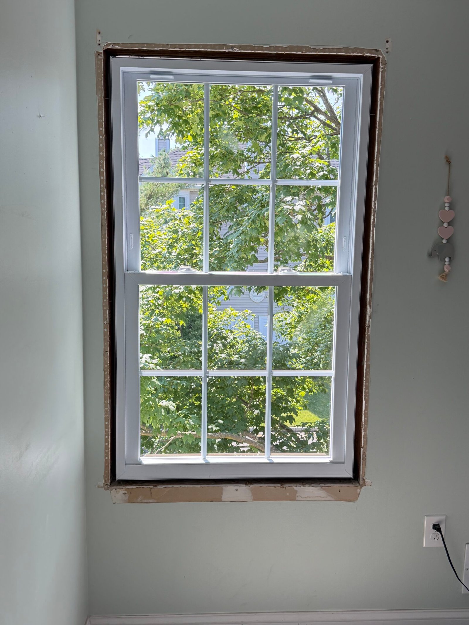 The second replacement window in place, with its interior perimeter still exposed.