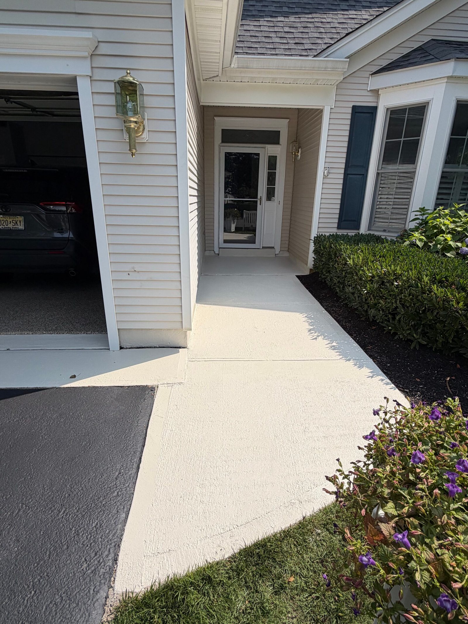 After: the completed light-colored walkway leading to the front entrance.