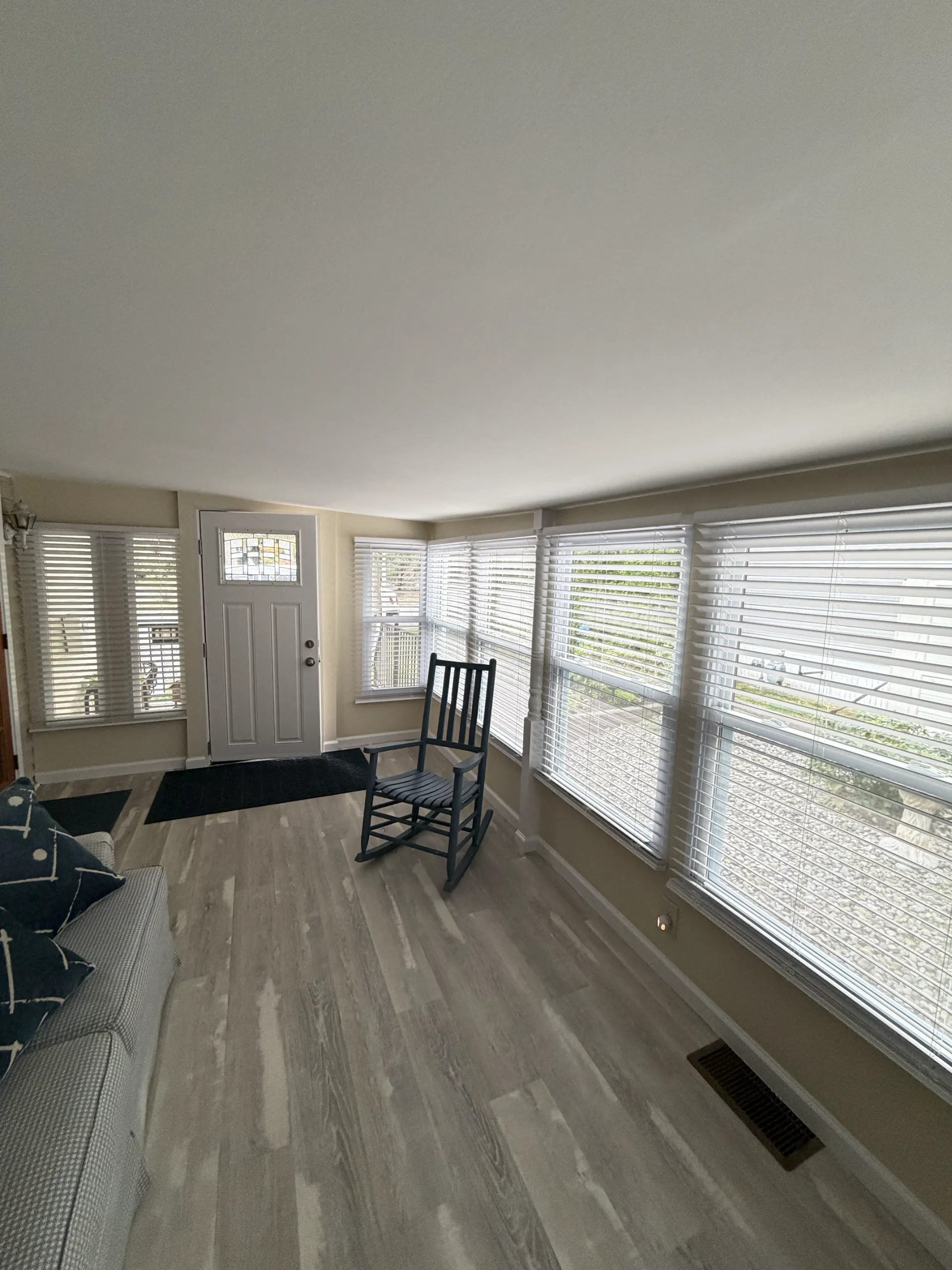 After: the finished sunroom looking along the window wall toward the entrance.