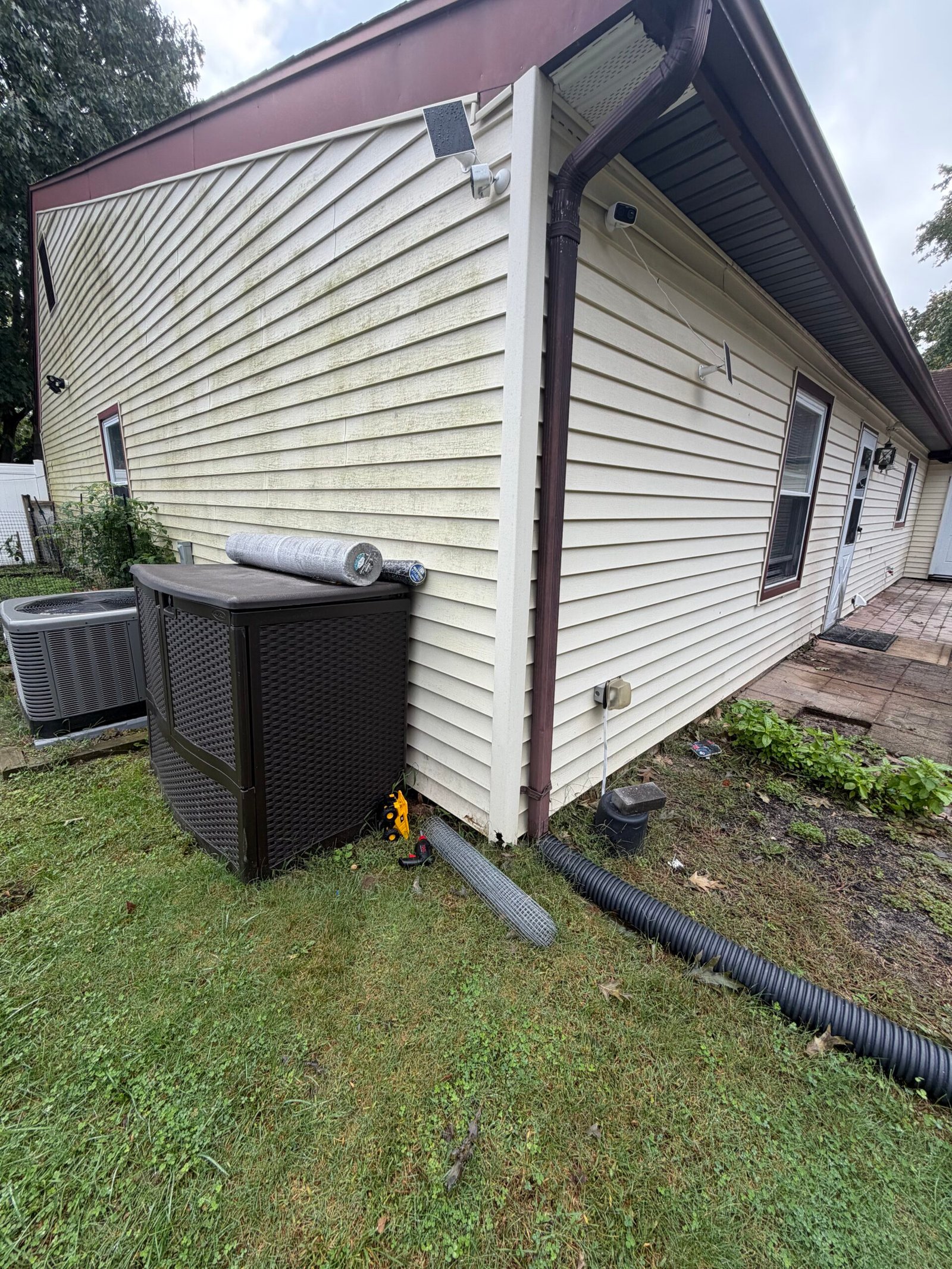 The outside corner and adjacent lawn before excavation and concrete work.