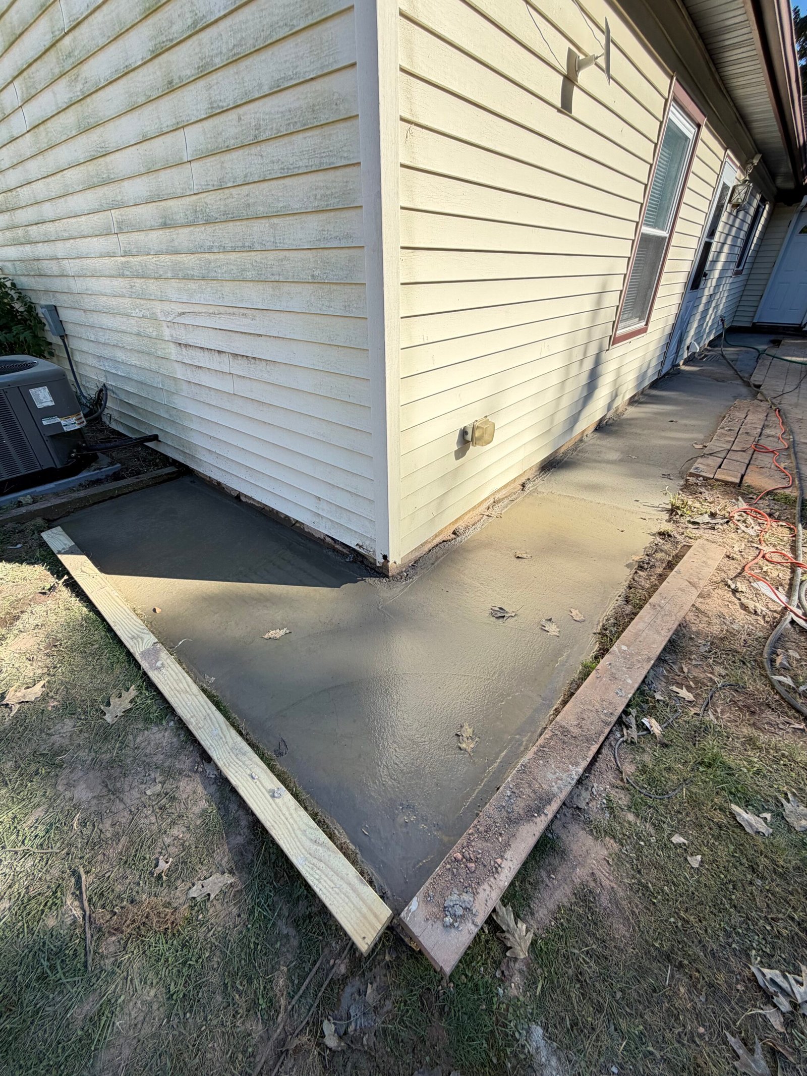The completed concrete pour around the outside corner, with edge forms still visible.