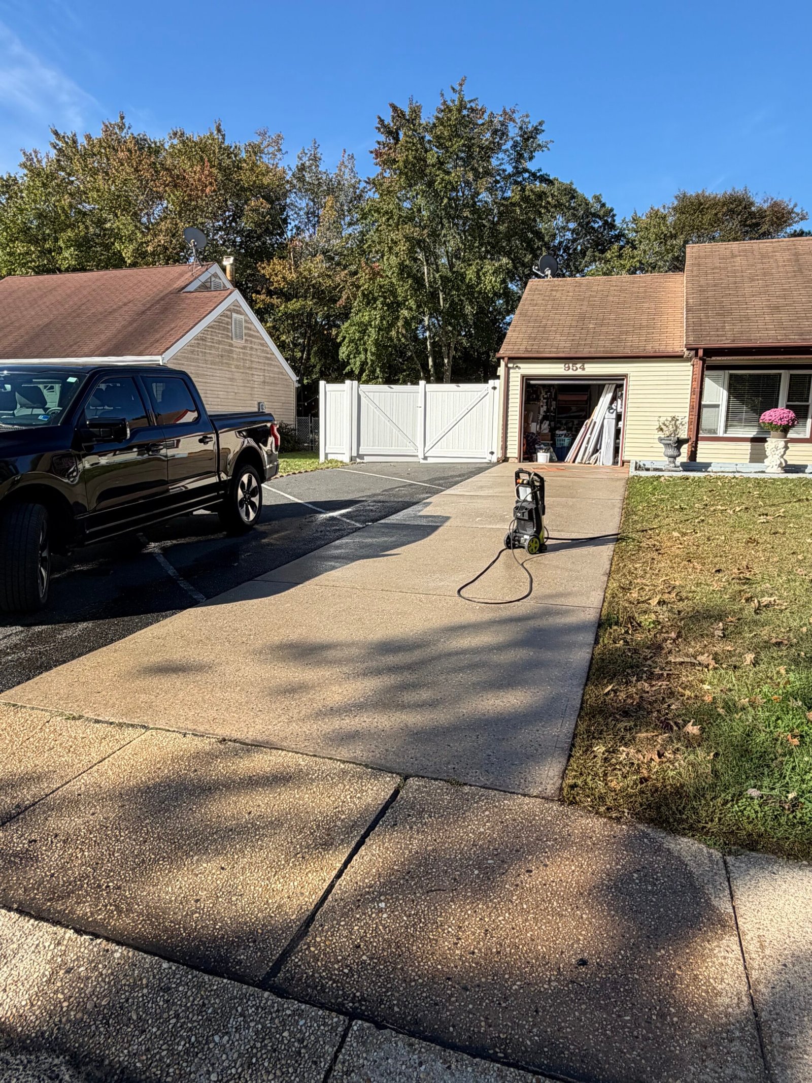 Before: the original concrete driveway surface leading toward the garage and house.