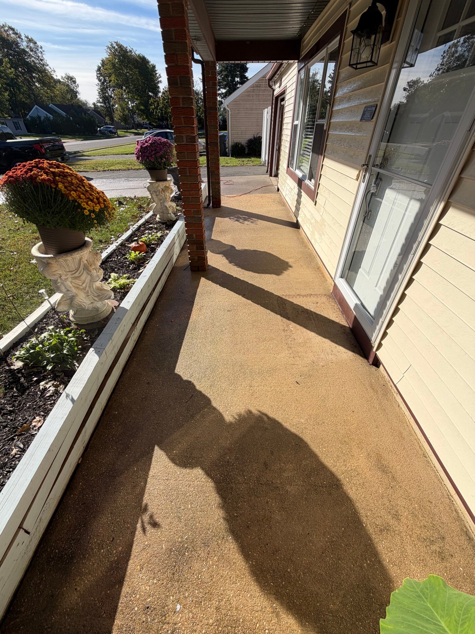 Before: the tan concrete floor along the covered front entry.
