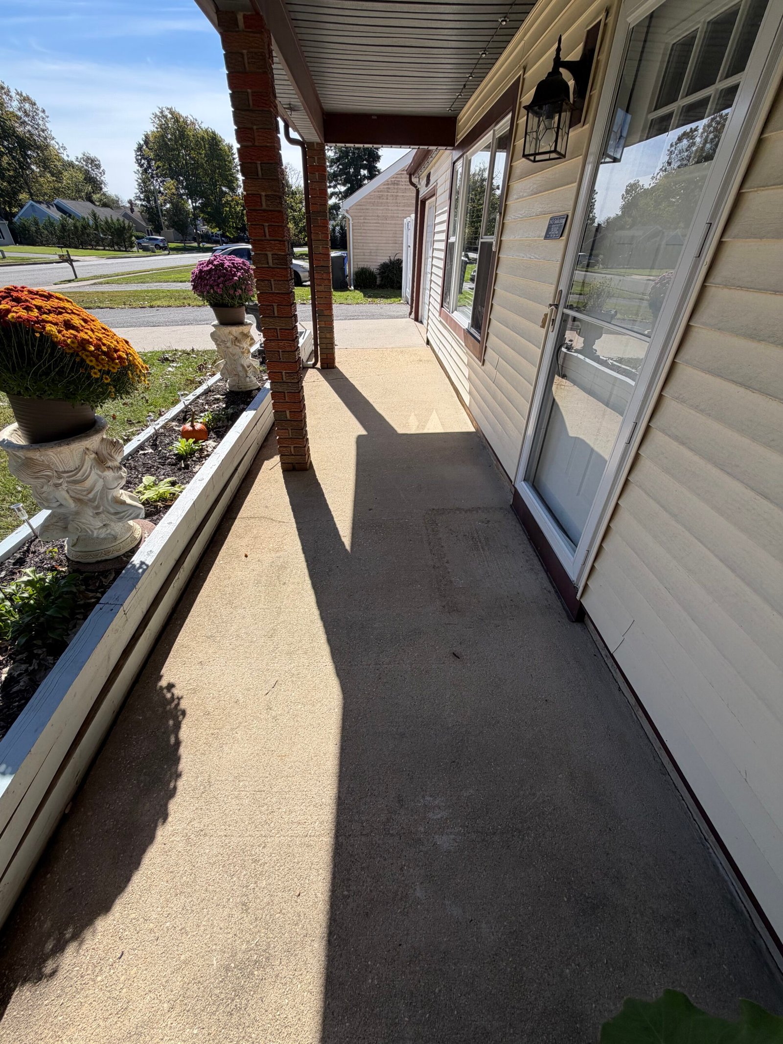 The covered-entry concrete floor before the new gray surface finish.