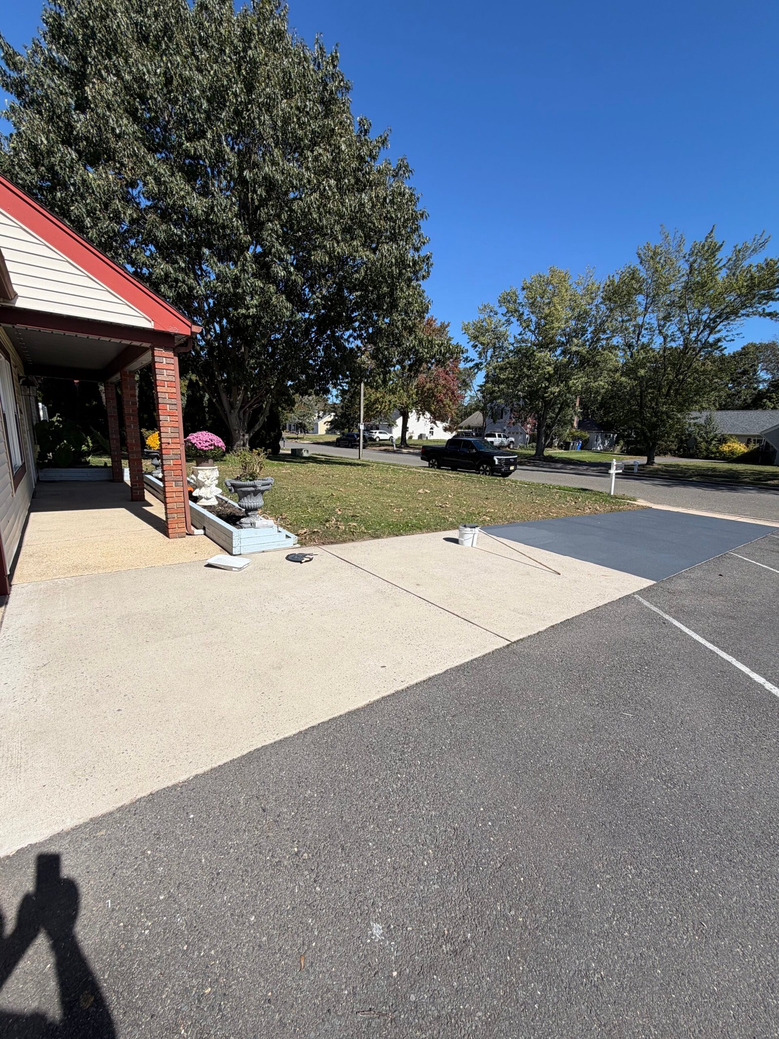 A wider view of the prepared driveway strip in front of the garage.