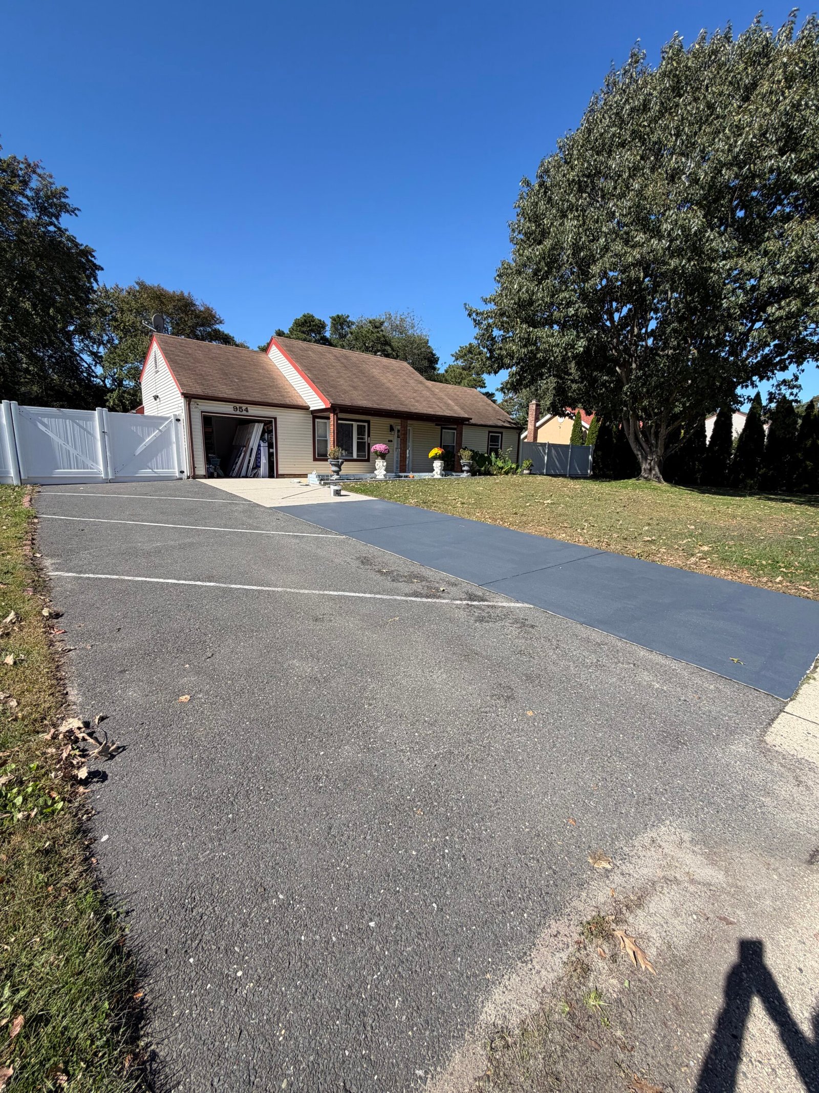 The gray-coated concrete strip alongside the existing asphalt parking area.