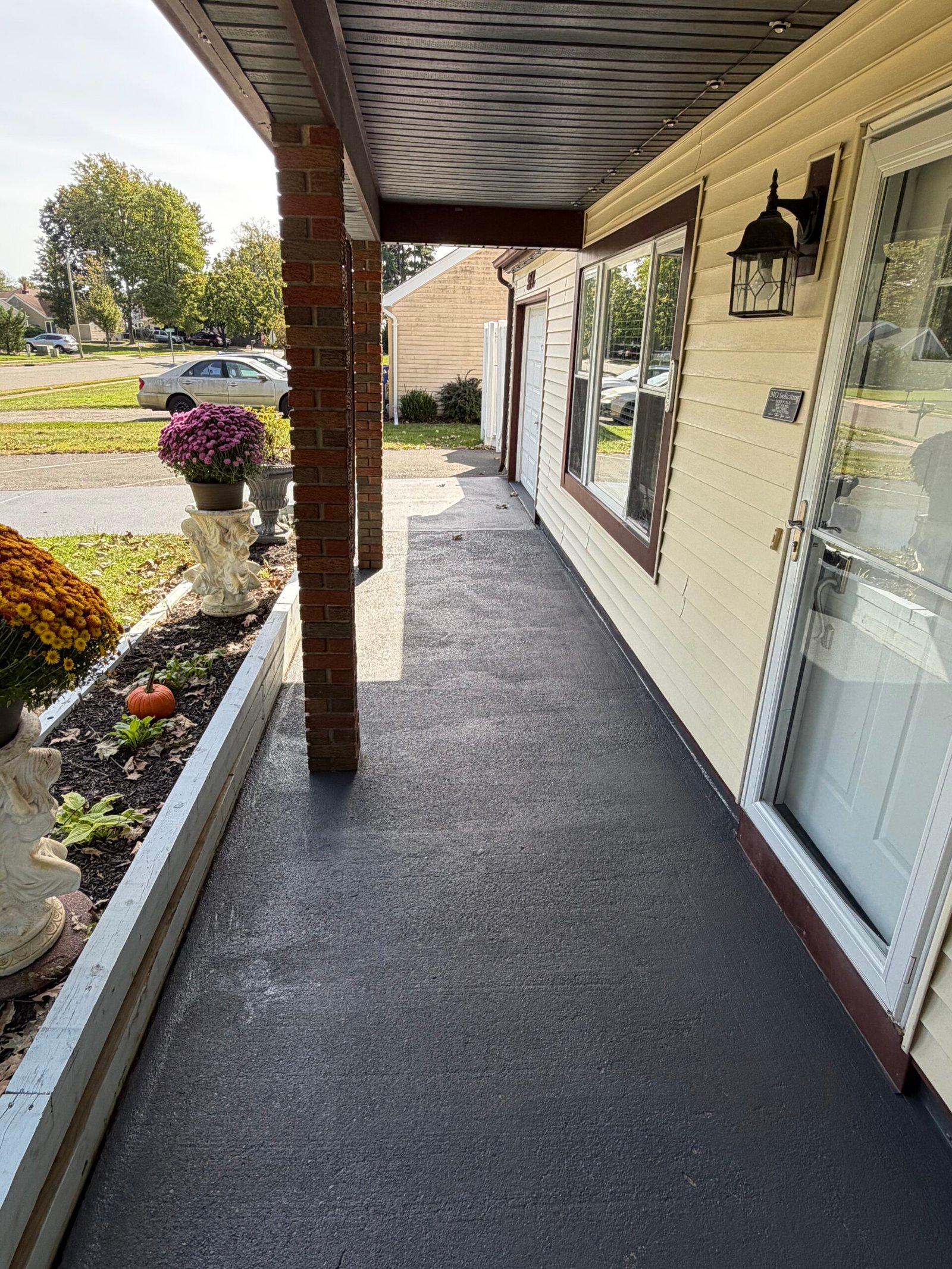 After: the covered-entry floor with a coordinated gray surface finish.