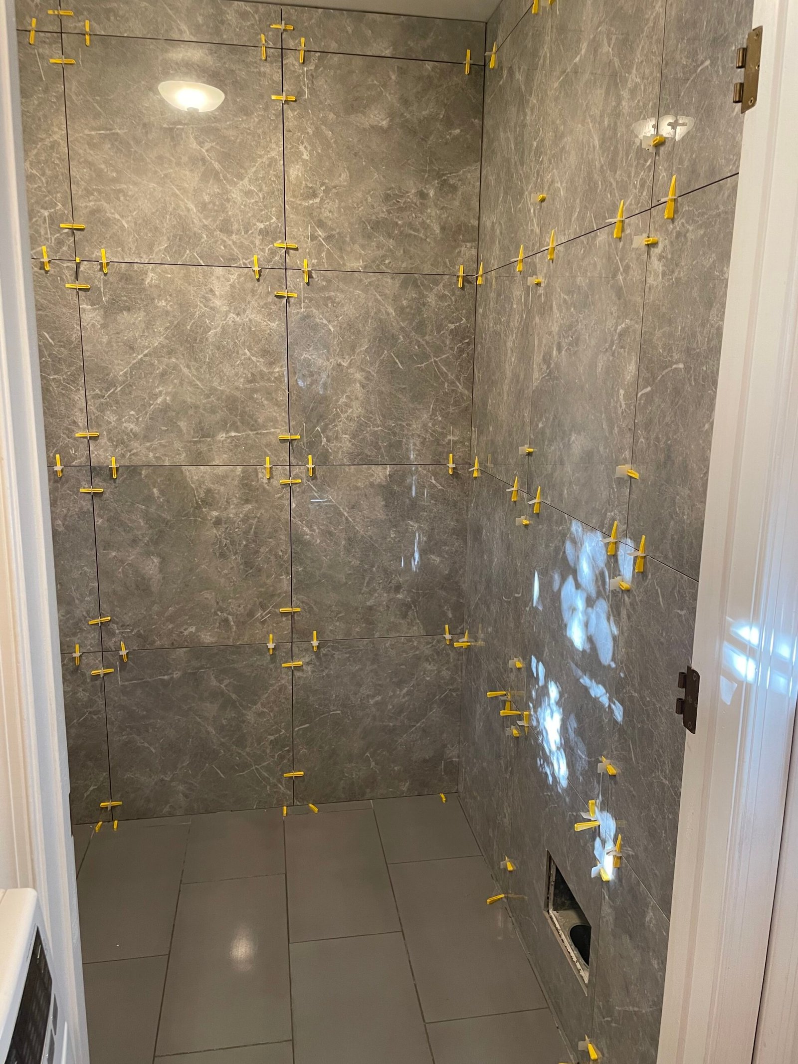 A closer view of the large wall tiles, corner and coordinated floor finish.