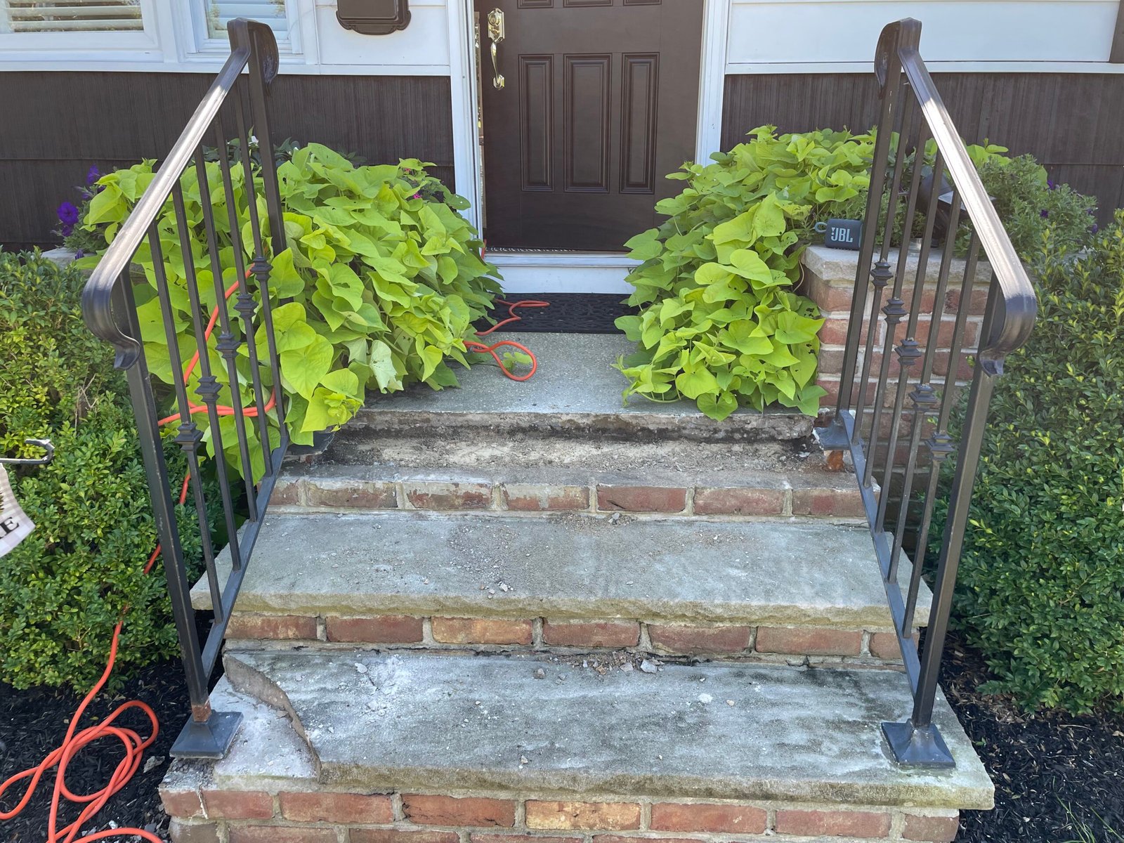 Before restoration: weathered gray steps, exposed brick risers and the earlier handrail arrangement.