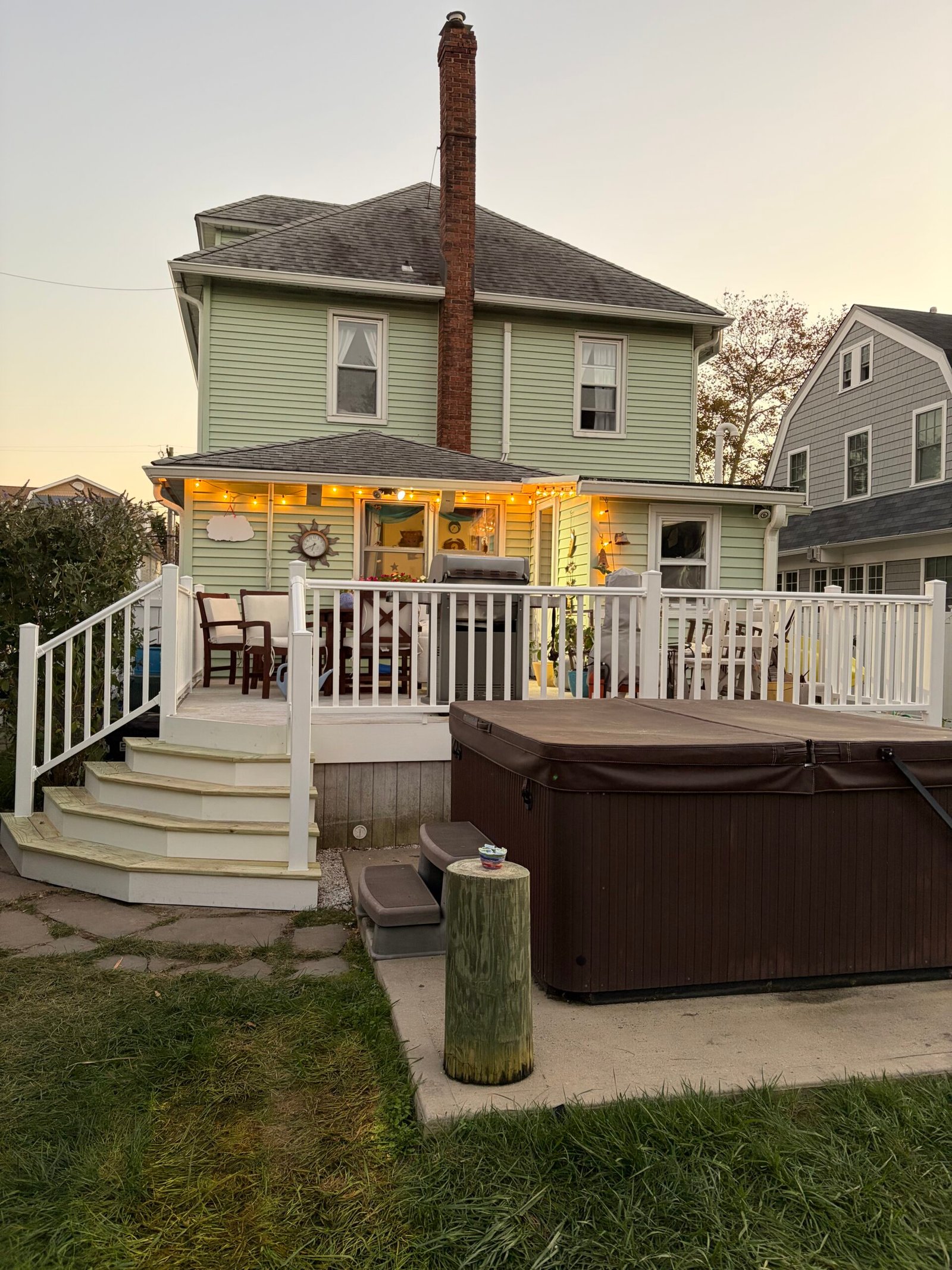 Evening view of the renewed deck railings and completed wraparound stairs.