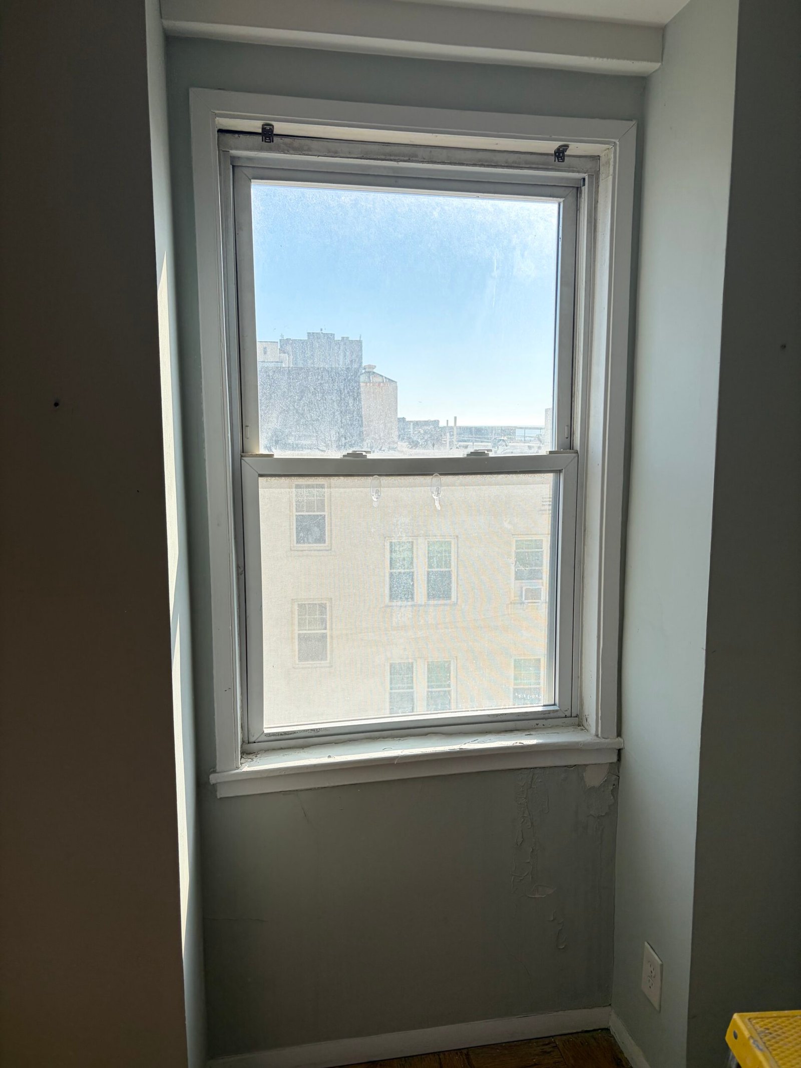Before: the original window and its existing interior trim.