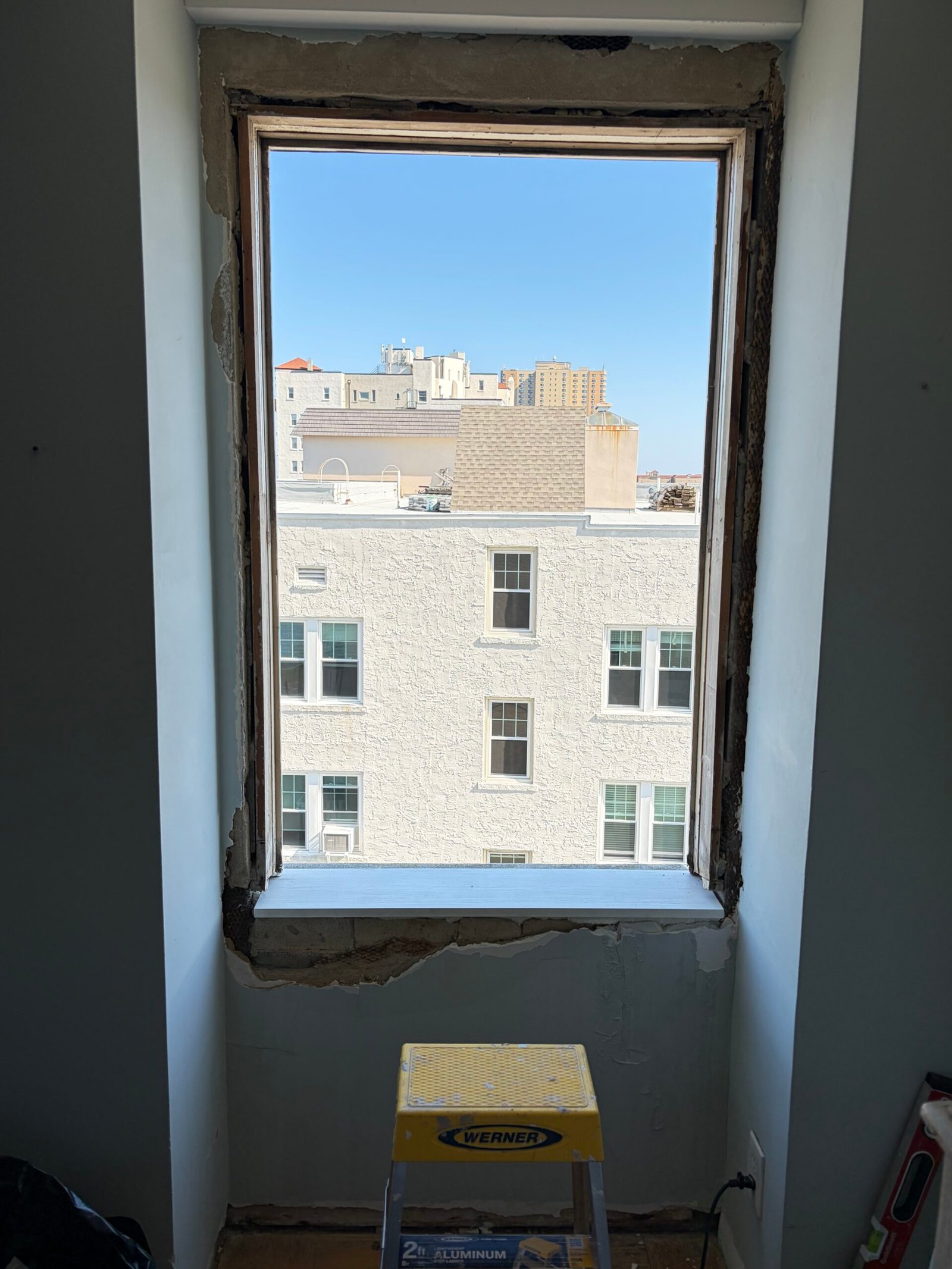 The opened window area with the surrounding wall edges exposed.