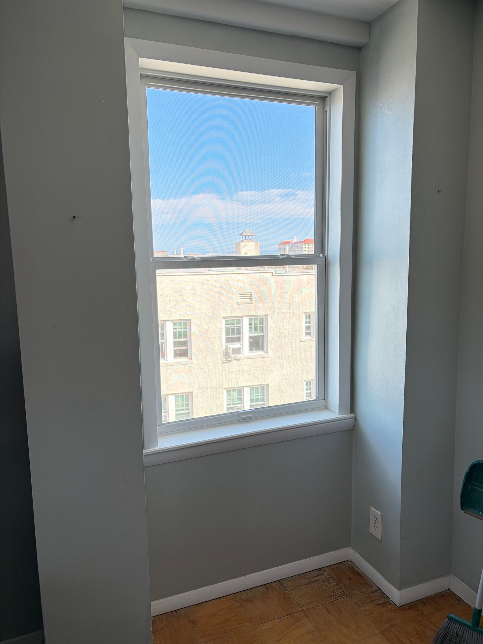After: the replacement window, white interior trim and restored surrounding wall finish.