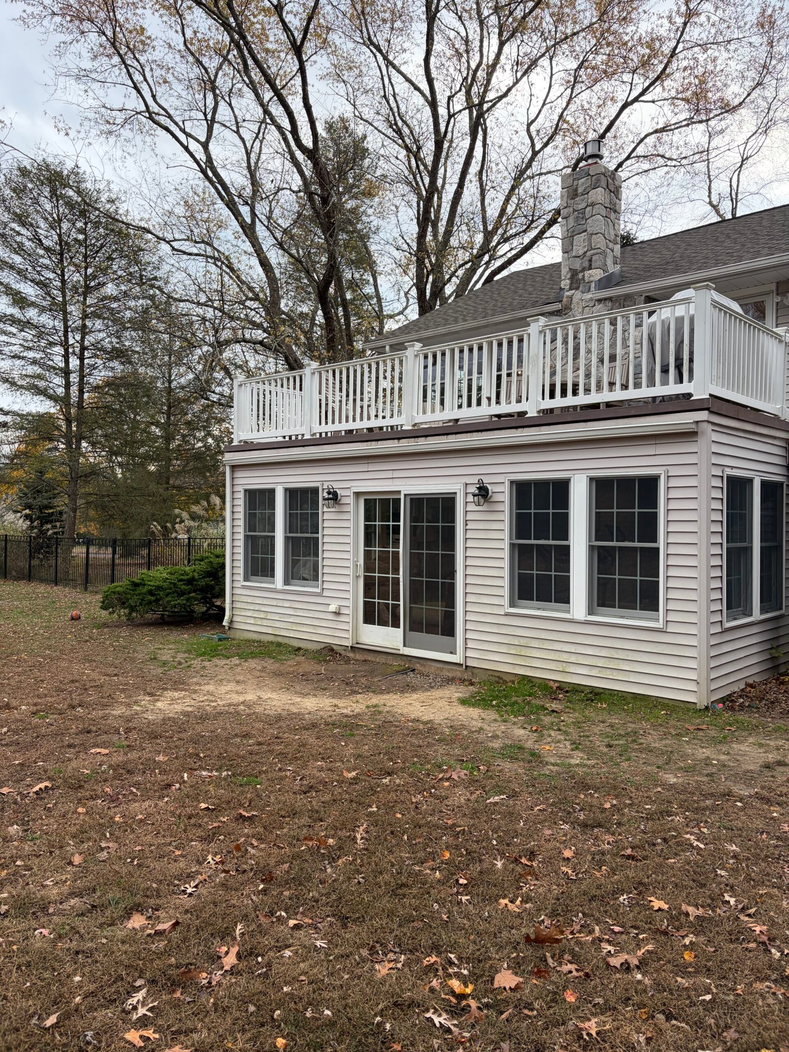 Before: the rear corner of the house and the unpaved area beside the doors.