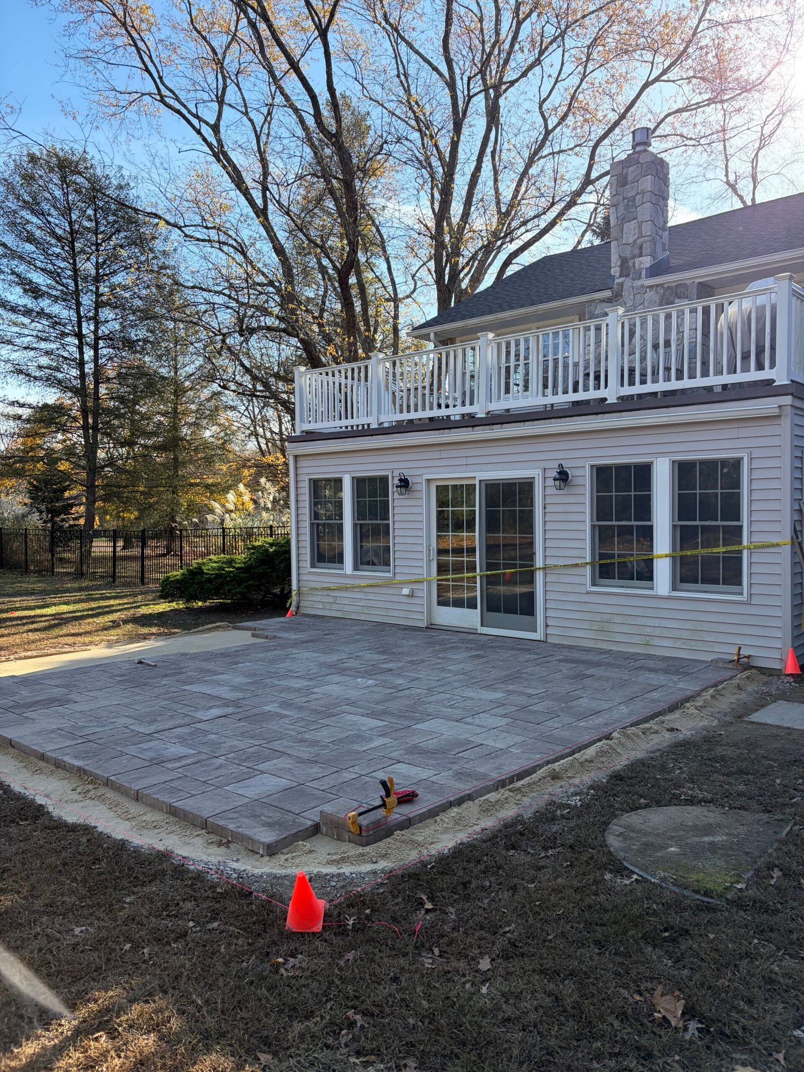Gray pavers laid in a mixed rectangular pattern before the outer border was finished.