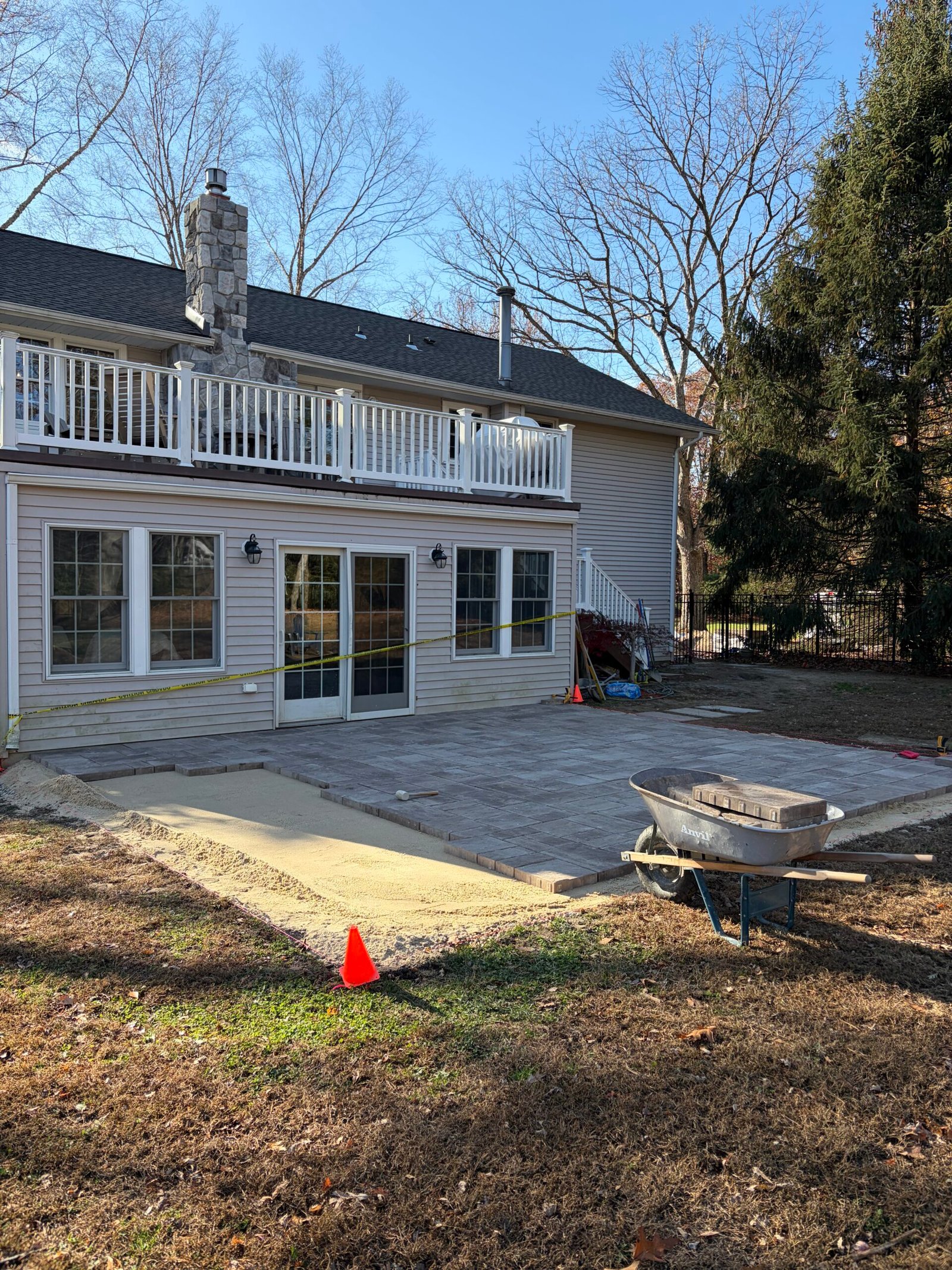 The paver surface taking shape, with material and equipment still beside the edge.