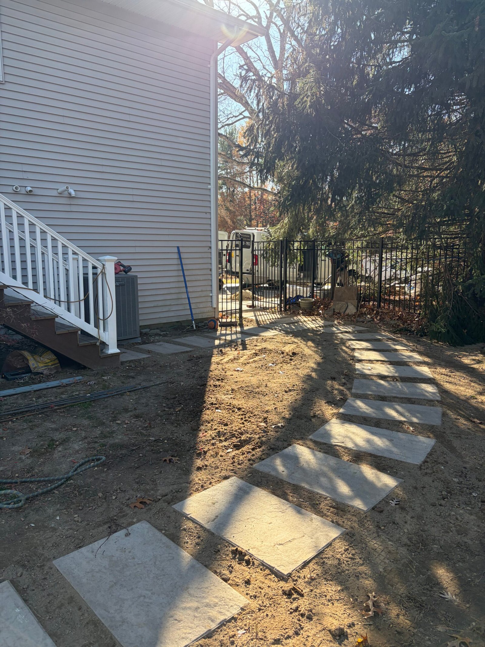 After: the curved line of stepping stones beside the house and planting area.