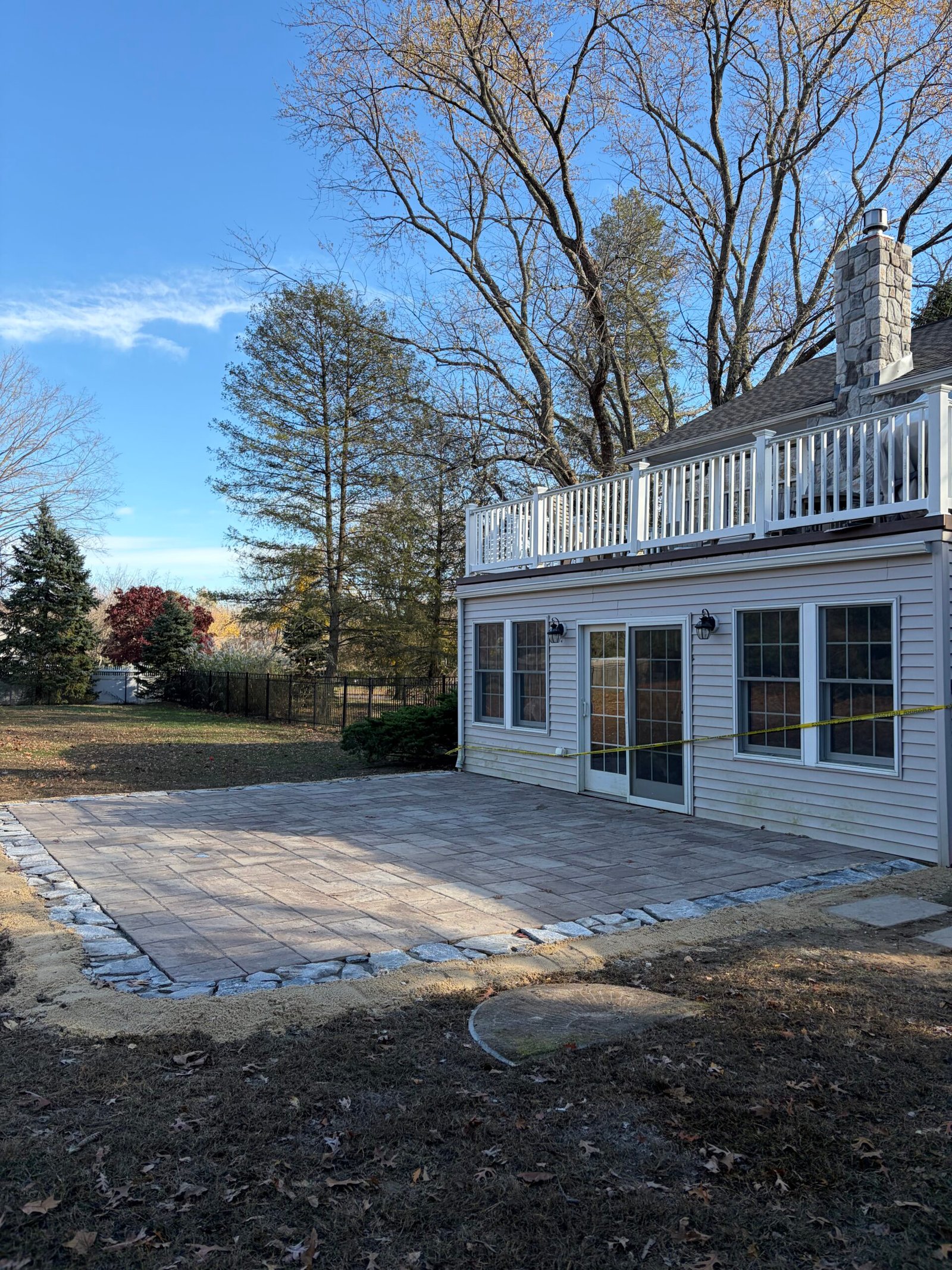 After: the finished patio surface beside the rear doors and corner of the house.