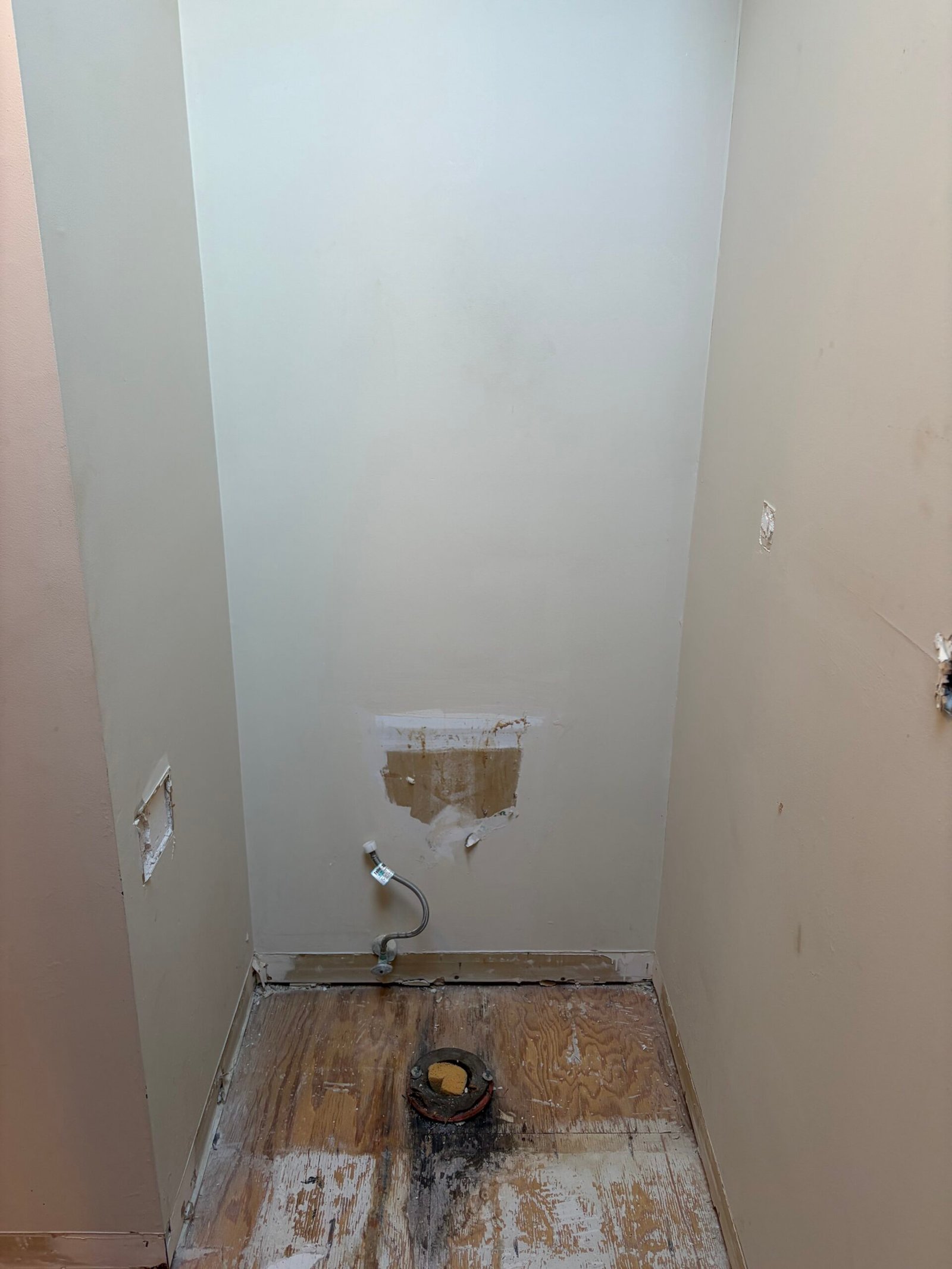 The toilet removed and the floor opened around the existing drain.