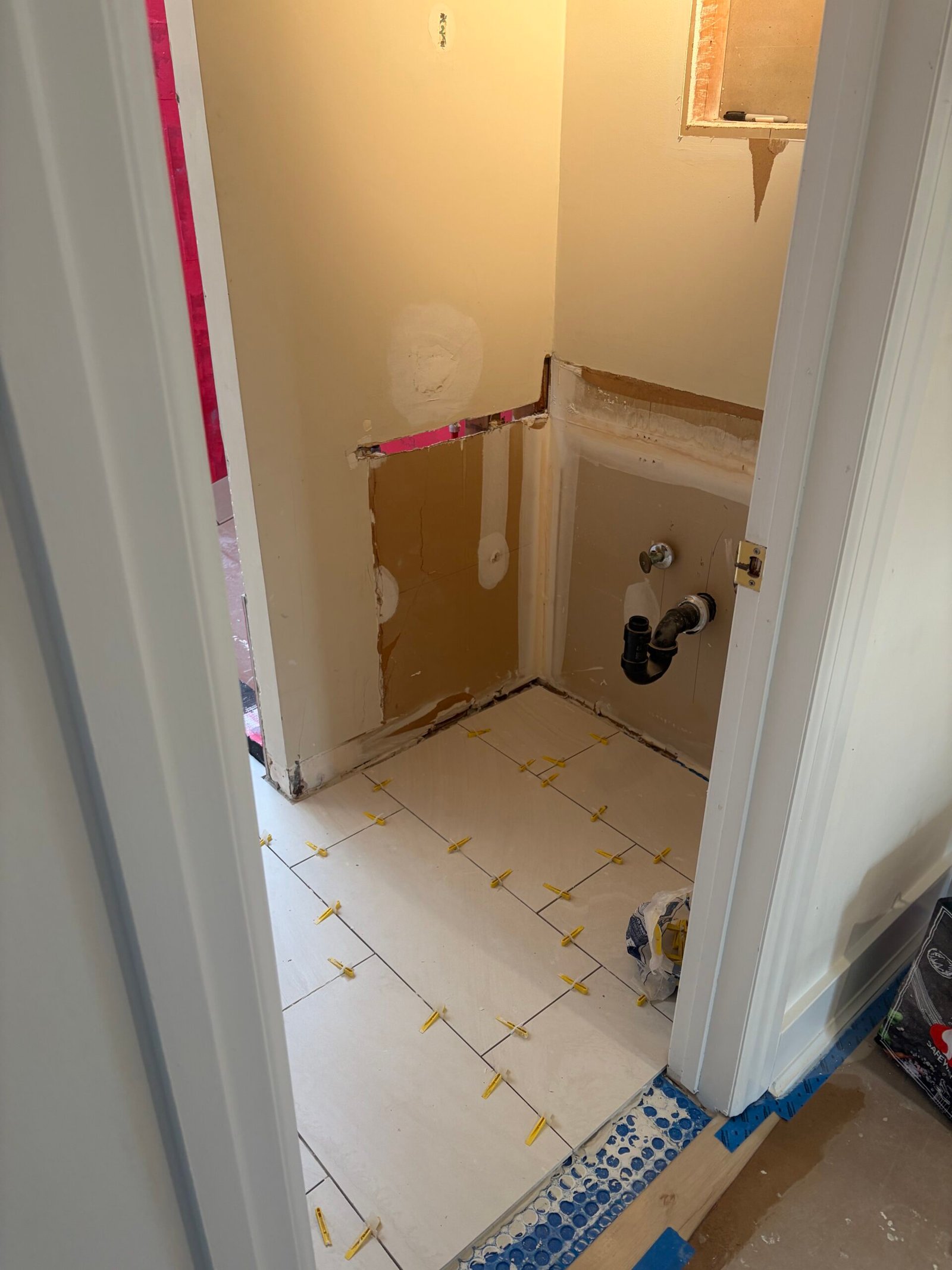 The new floor tile extending into the former vanity area.