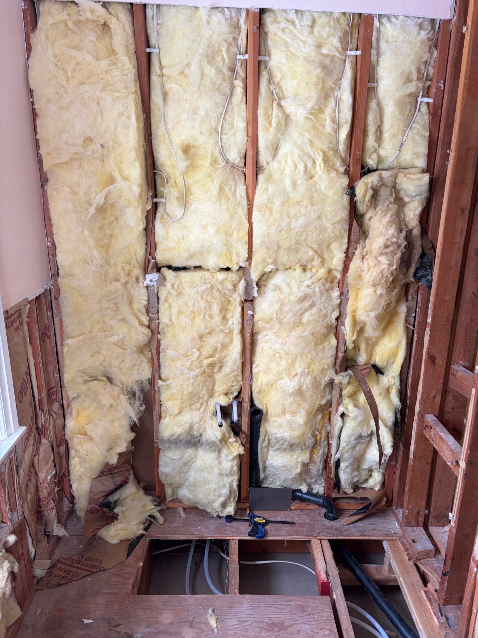 Exposed wall framing and the opened floor during the preparation work.