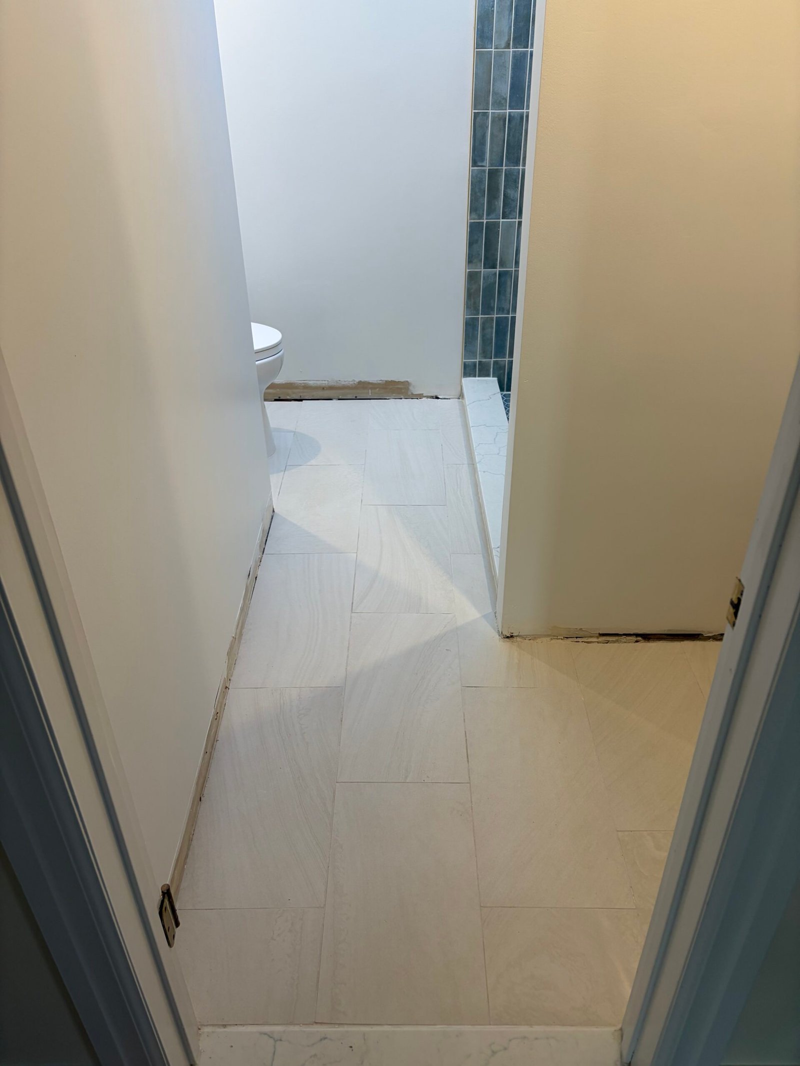 The light bathroom floor and updated toilet area during finishing.