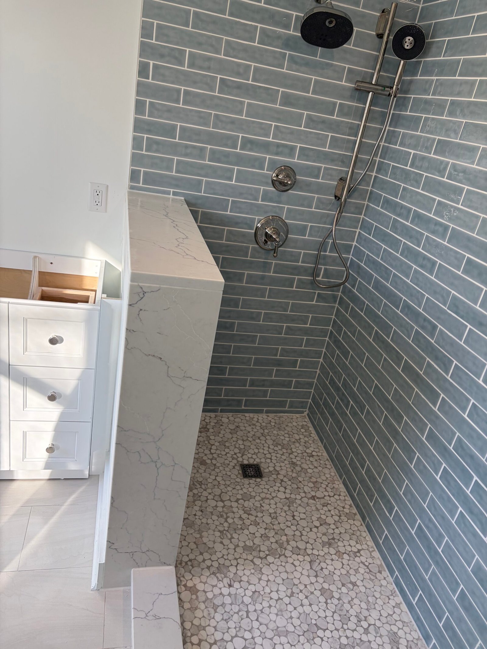 After: the tiled shower wall, fittings and handheld shower.