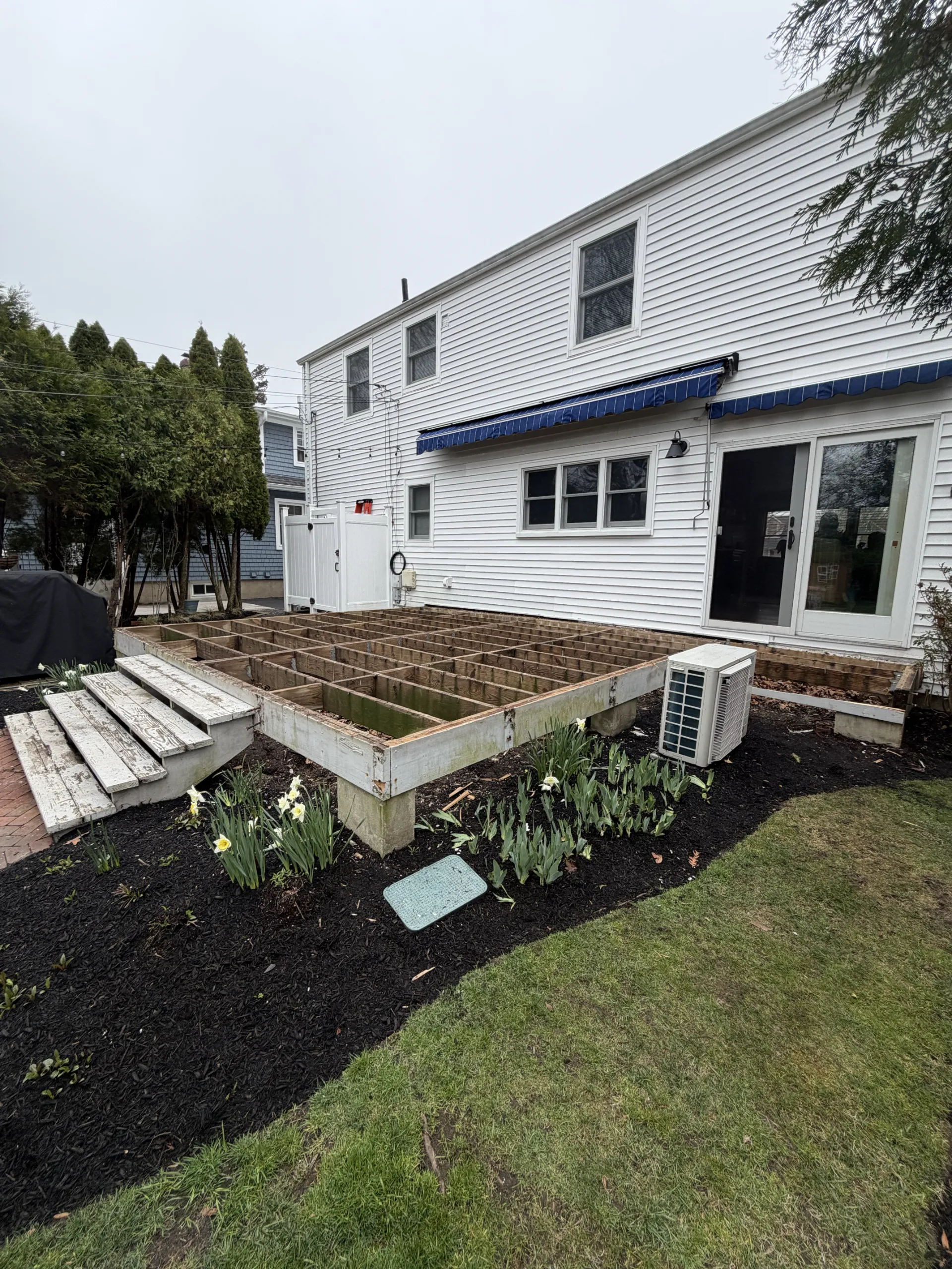 The exposed timber joist layout beside the house