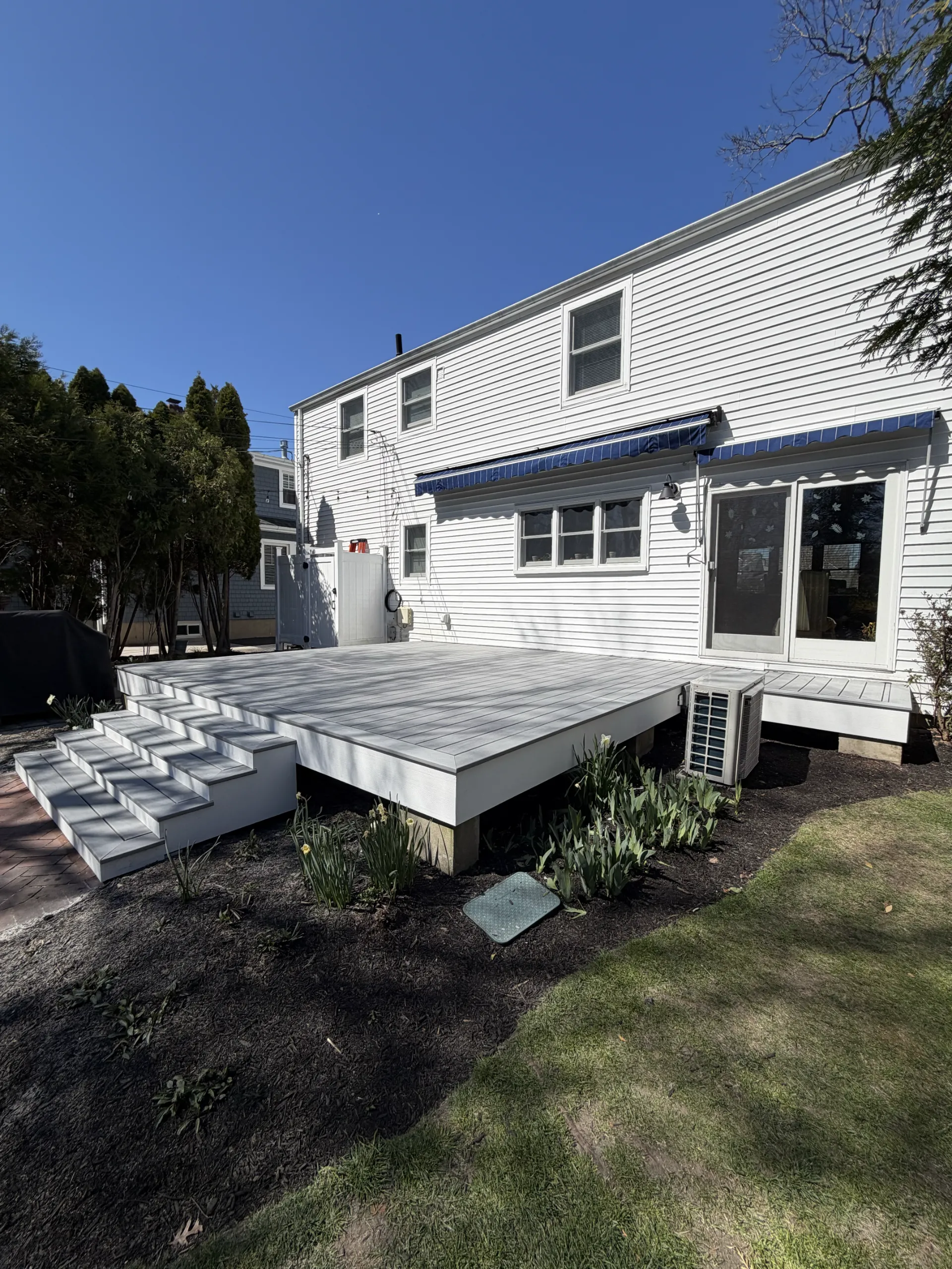 Gray deck surface with white fascia and stair risers