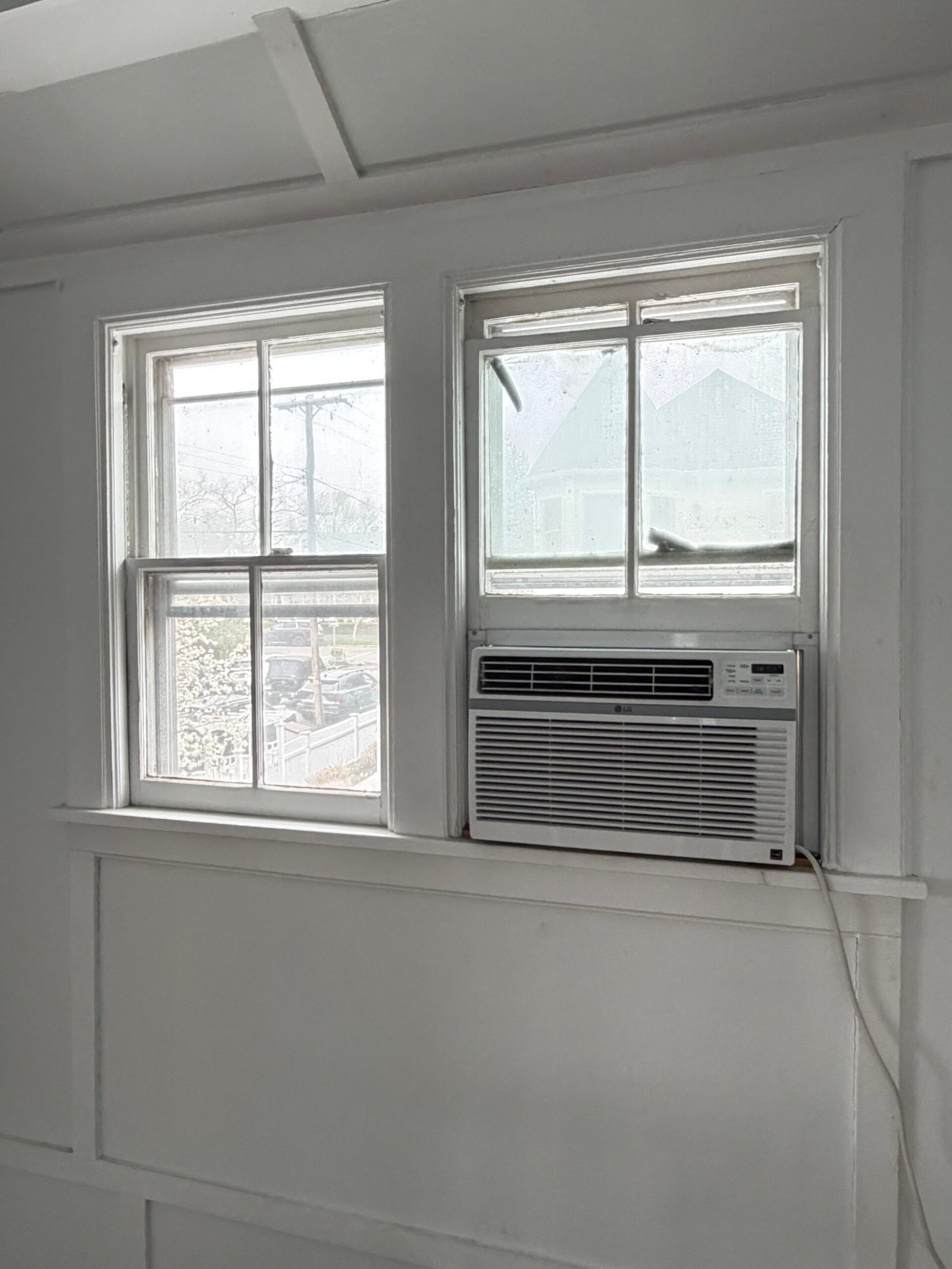 Before: a pair of existing windows, including a window-mounted air conditioner.