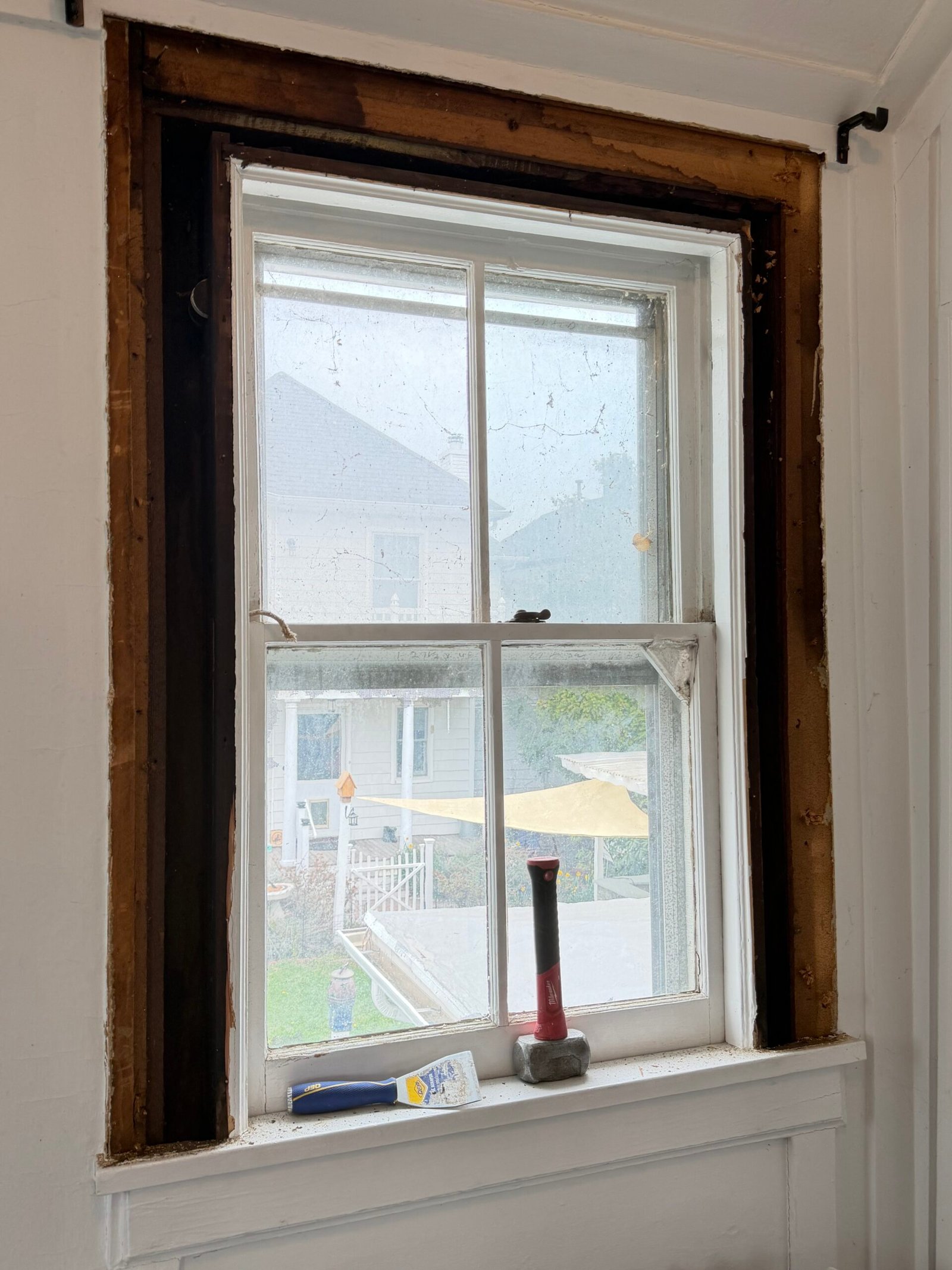 Interior casing opened around an existing single window to expose the timber perimeter.