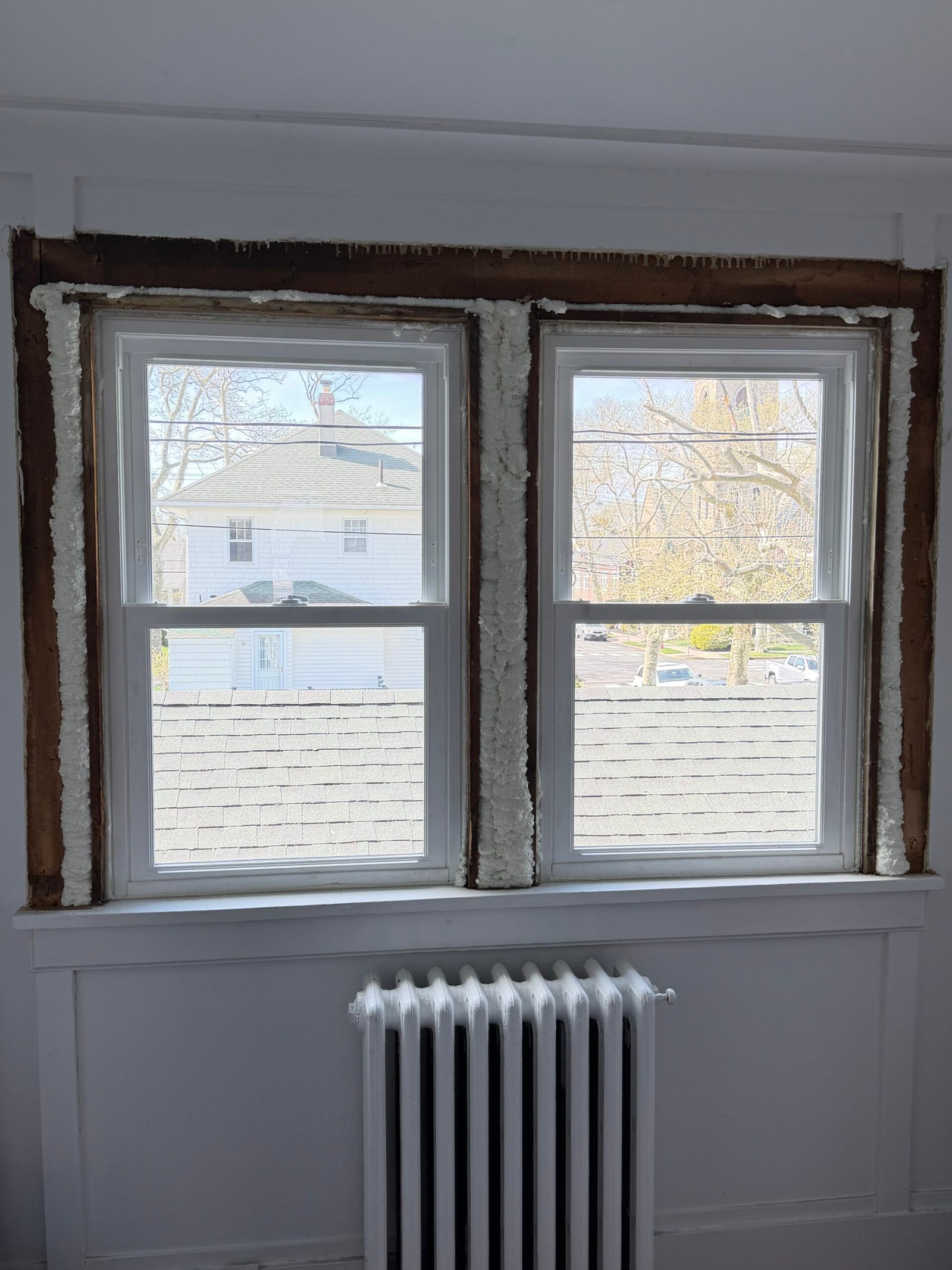 Another pair of replacement windows in place above the radiator before final interior trim.