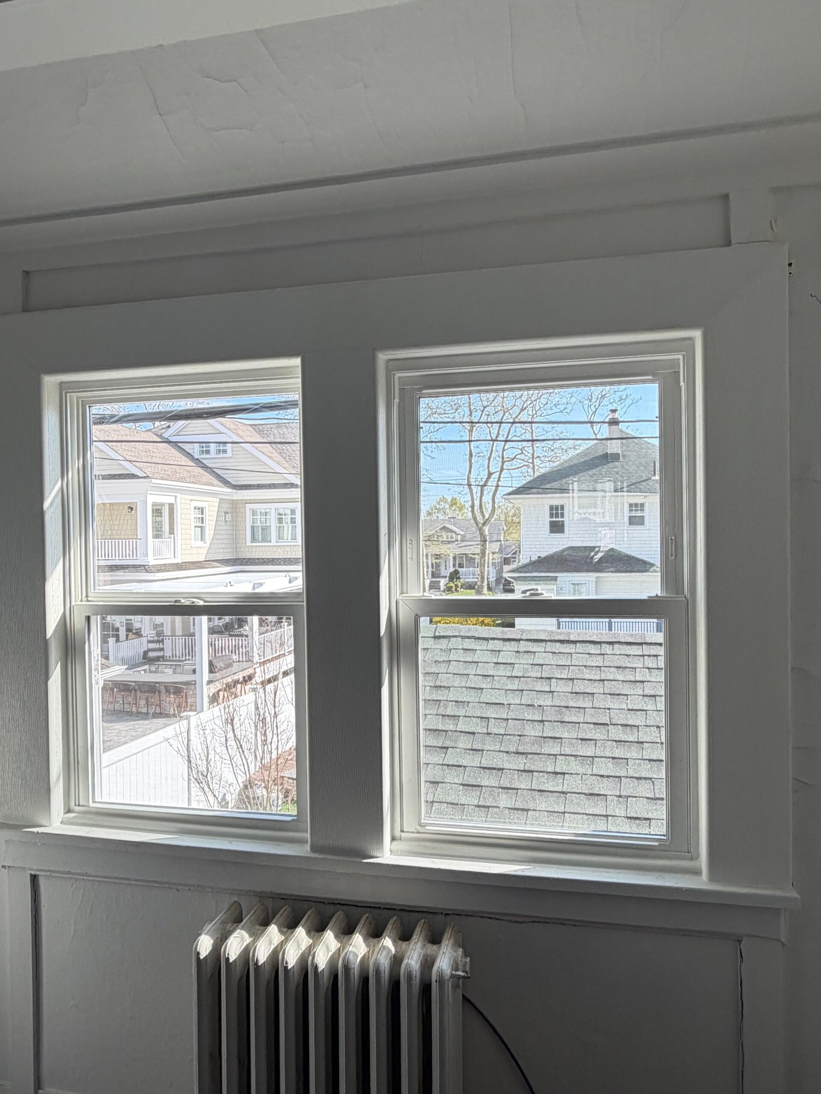 After: the paired replacement windows with finished white interior trim and sill.