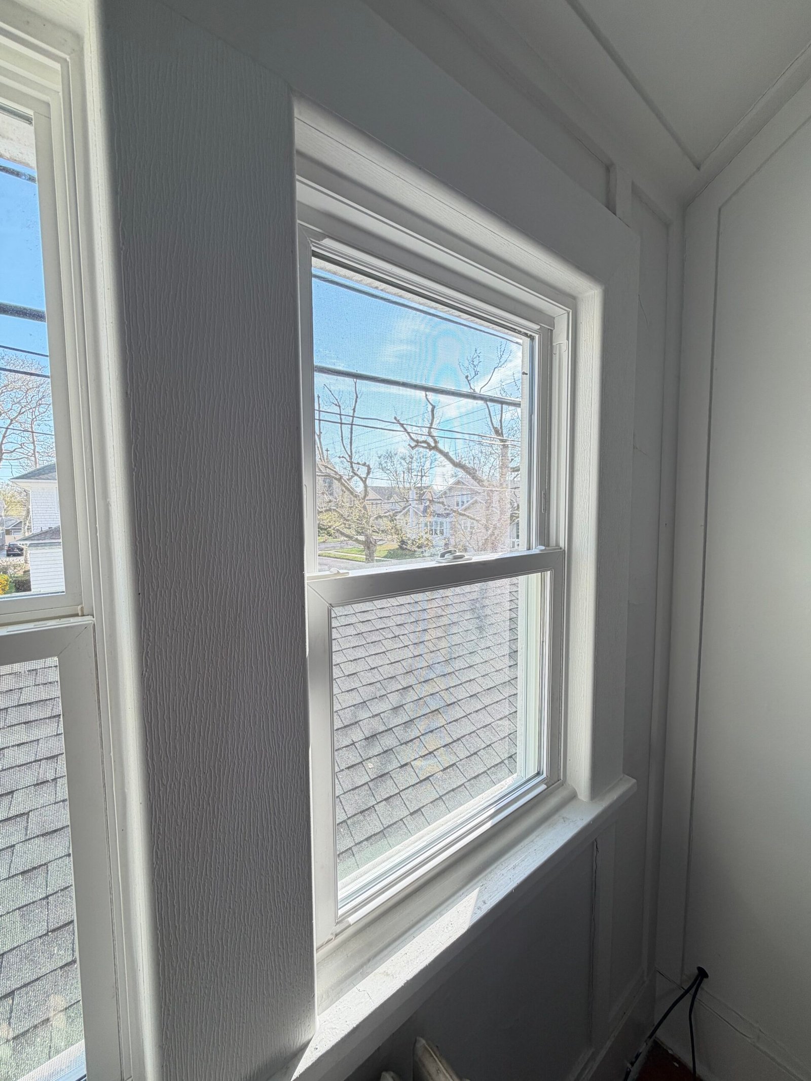 After: a closer angle on the white casing and central trim between the paired windows.