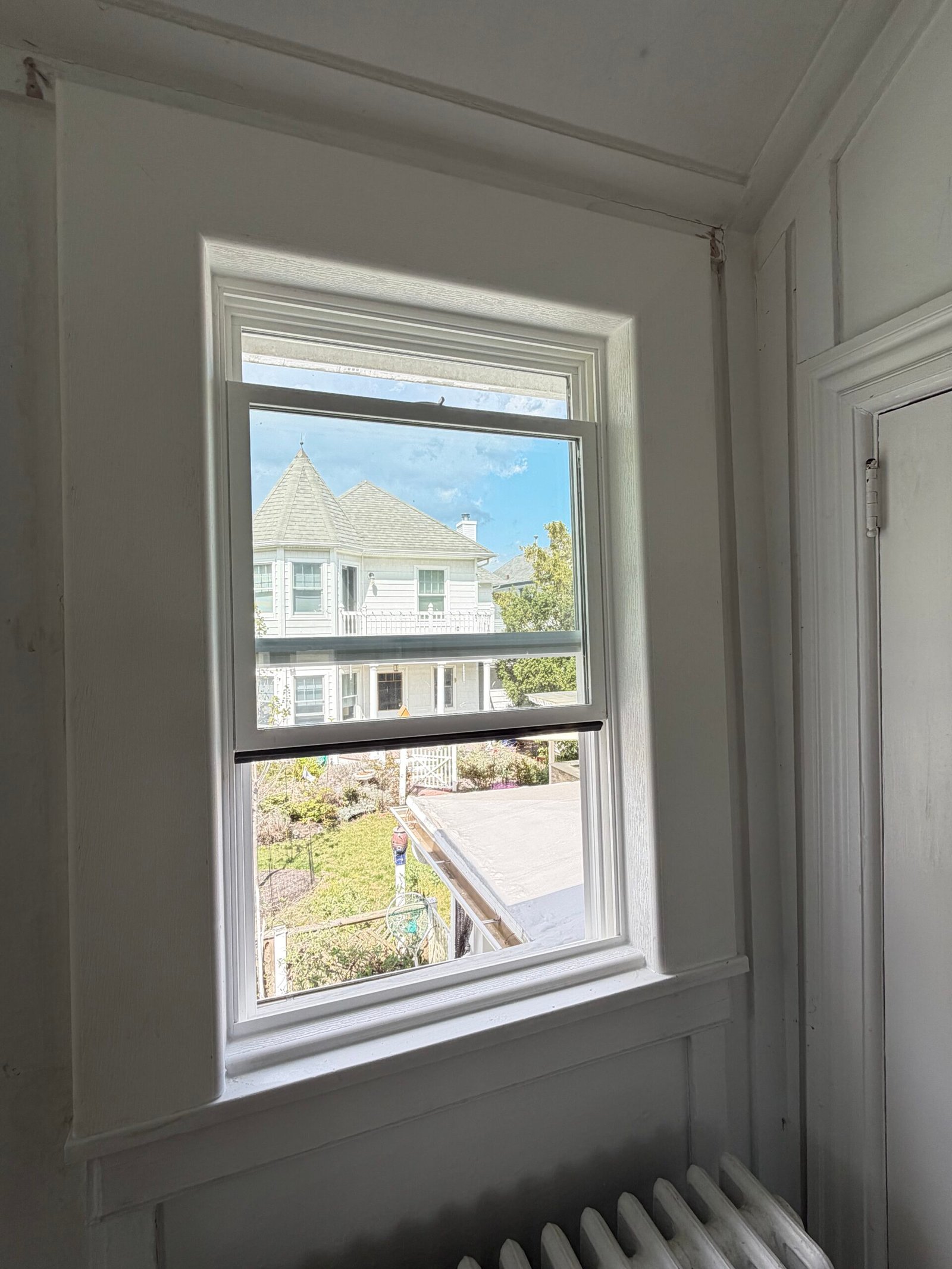 After: the replacement single window with its finished white casing and sill.