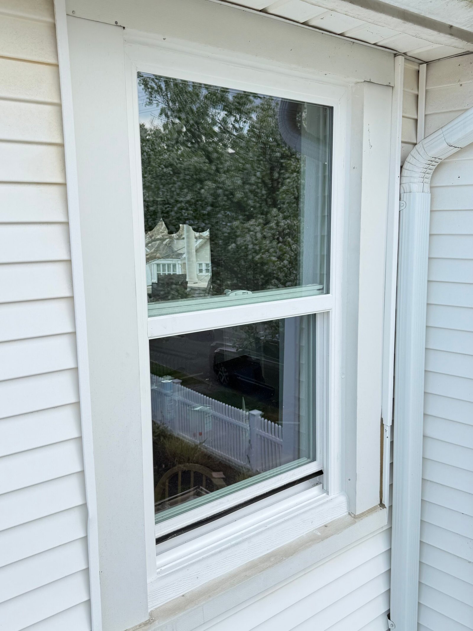 After: an exterior view of a completed single window beside the covered porch.