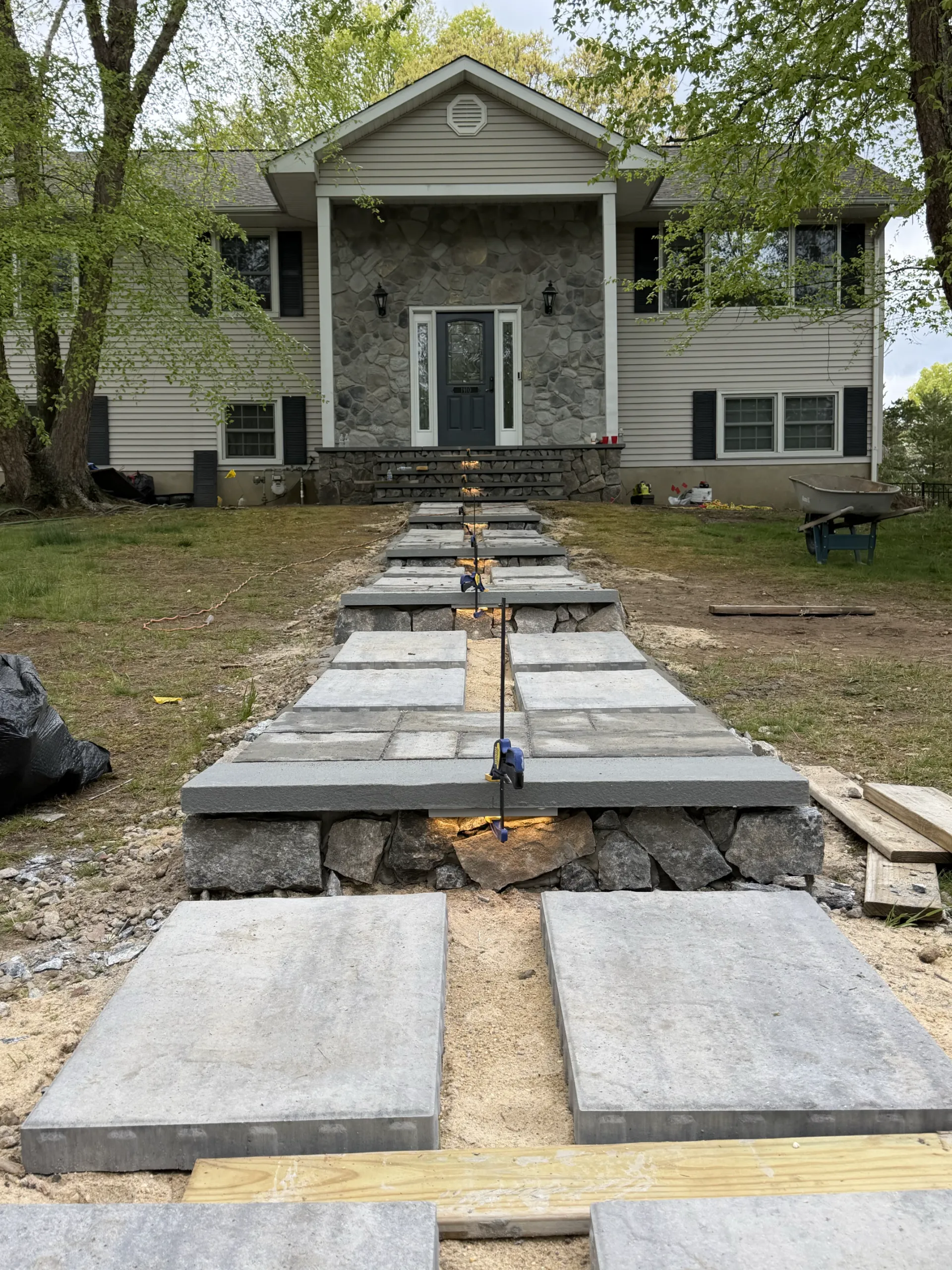 Large gray slabs during installation, with fitting clamps and unfinished edge details.