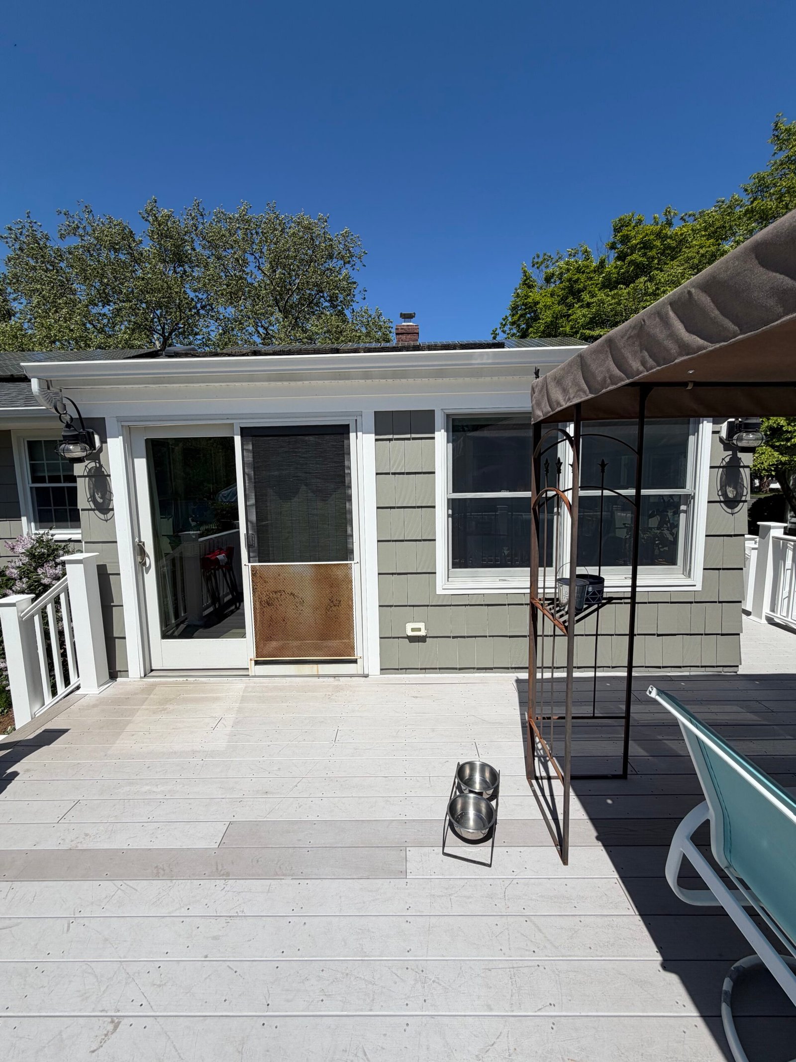 After: the painted rear wall beside the deck doors and windows.