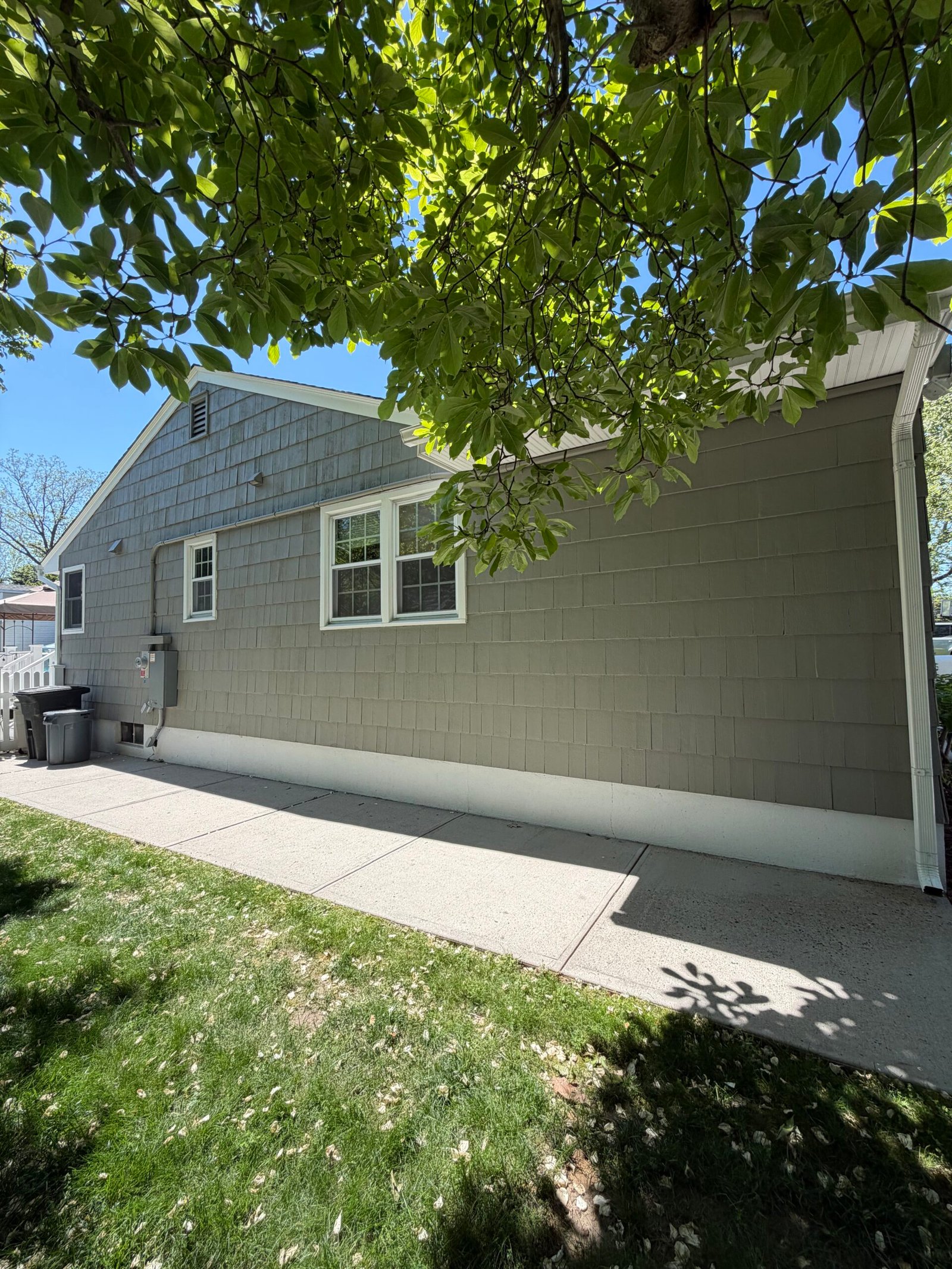 After: a wide view of the finished side elevation and lower white band.