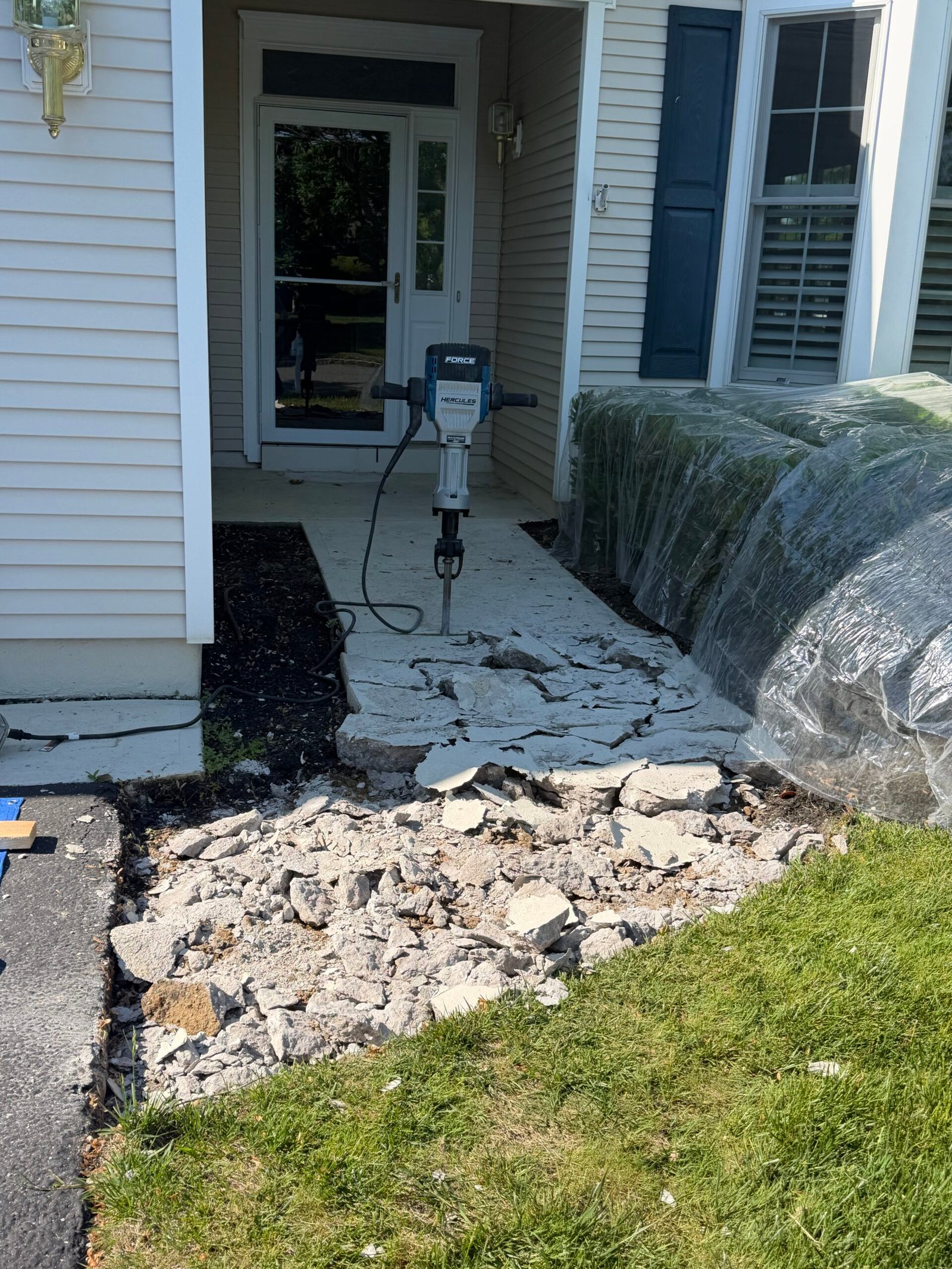 Breaking out the old walkway with a demolition hammer near the front door.