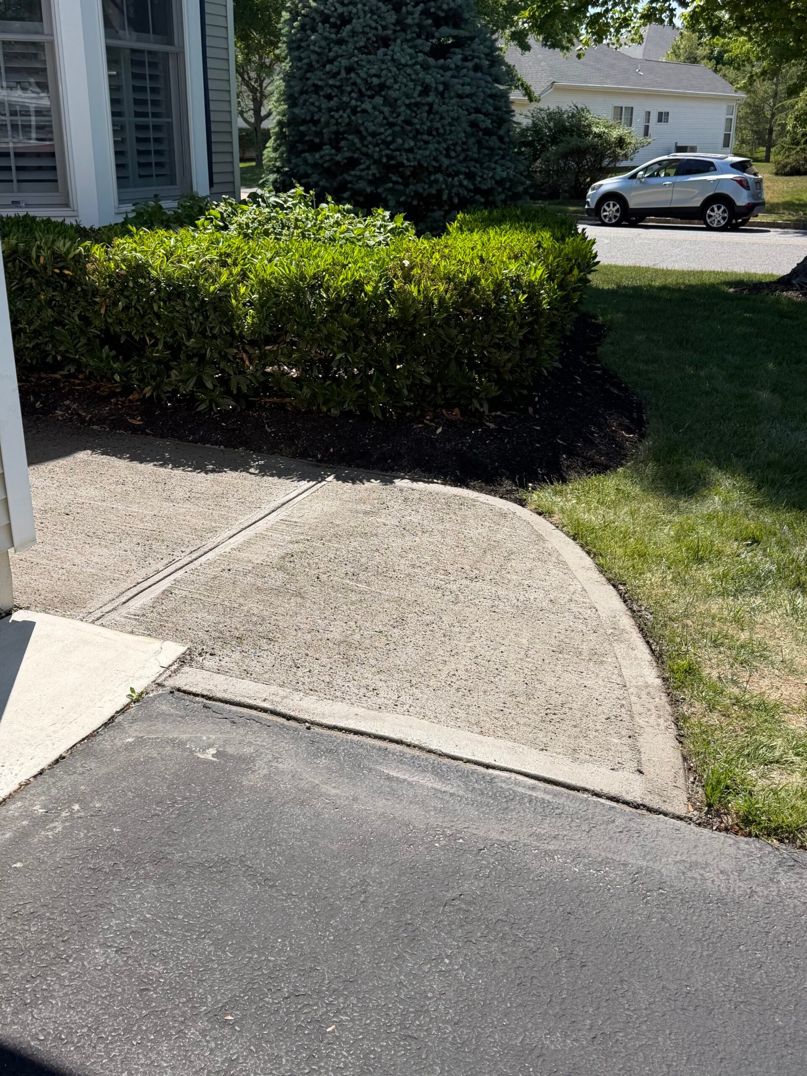 The curved outer edge and joint detail at the driveway connection.