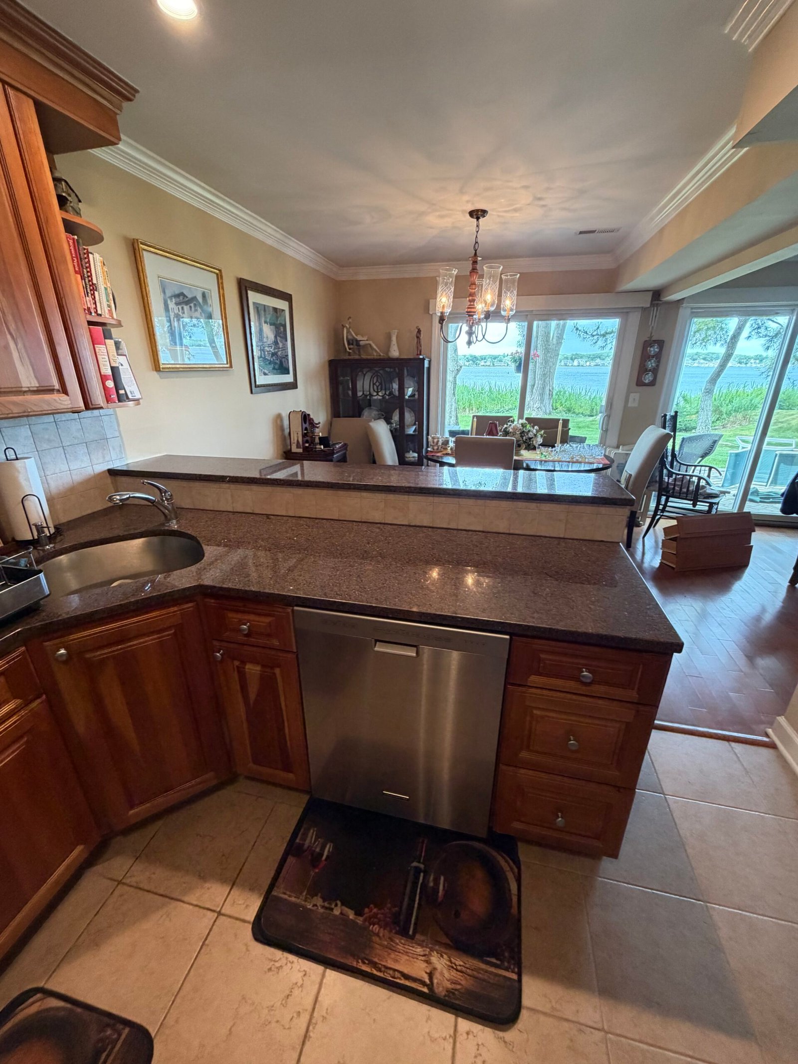 The existing kitchen-side counter, sink area and raised peninsula top.