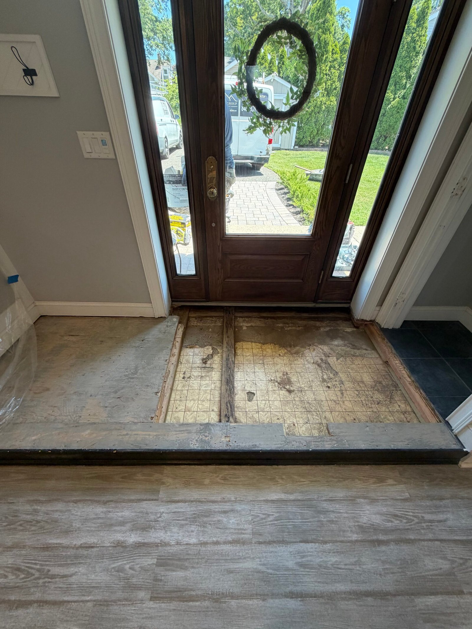 The cleared main entry area, with the adjoining tiled area still in place.