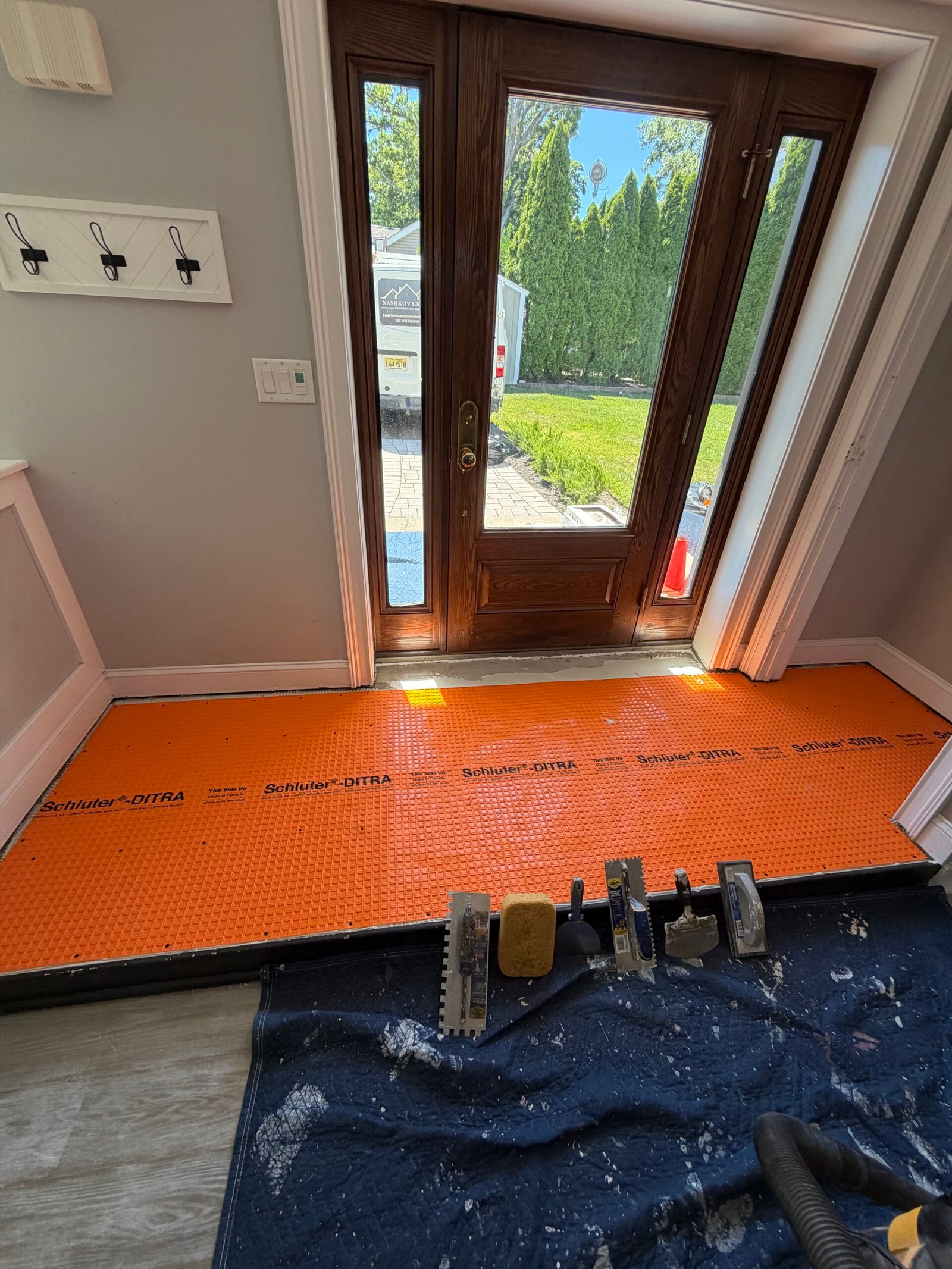 Orange tile underlayment fitted across the rebuilt entry area.