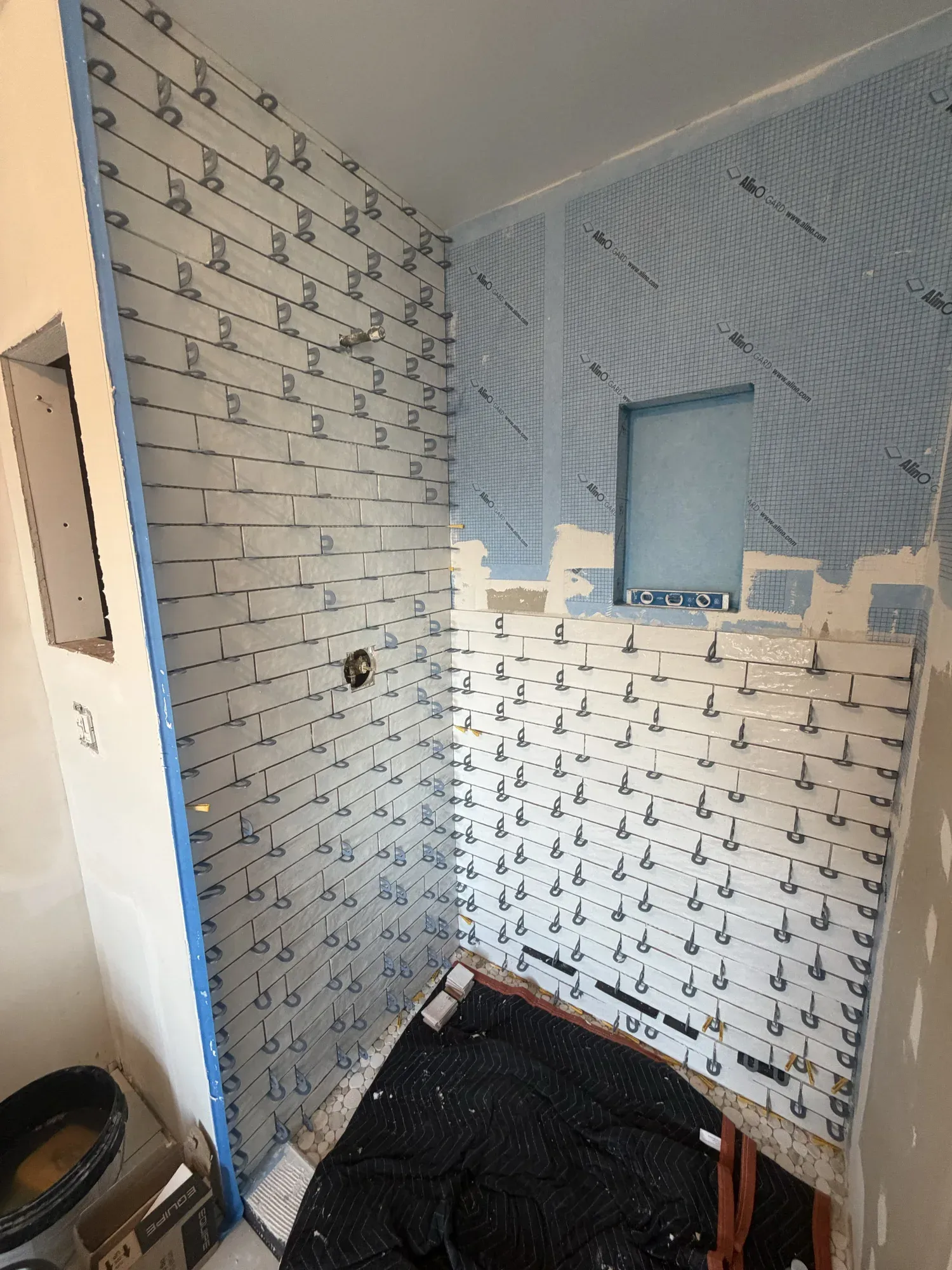 Shower wall tile installation in progress