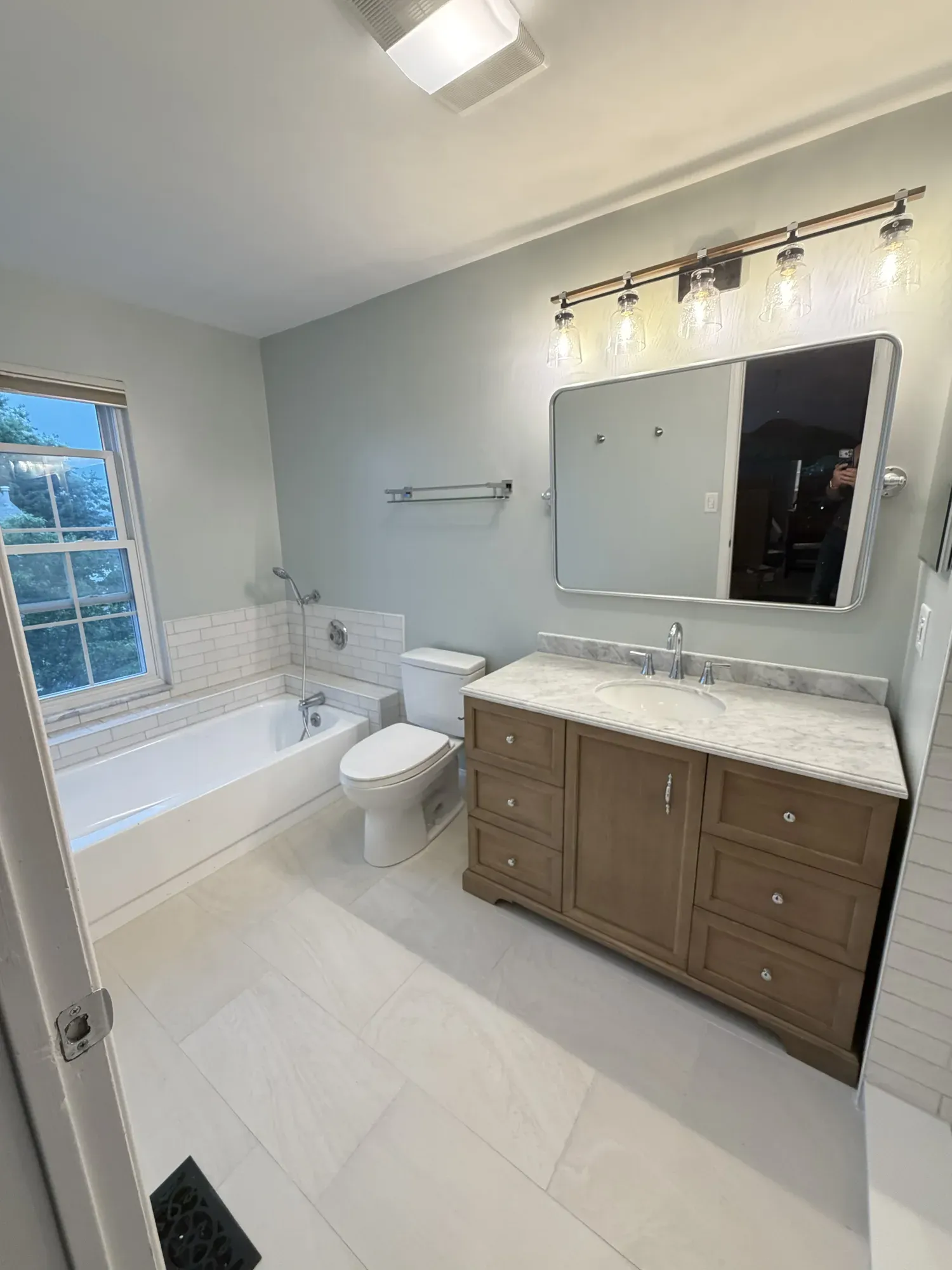 Finished vanity, countertop, mirror and lighting