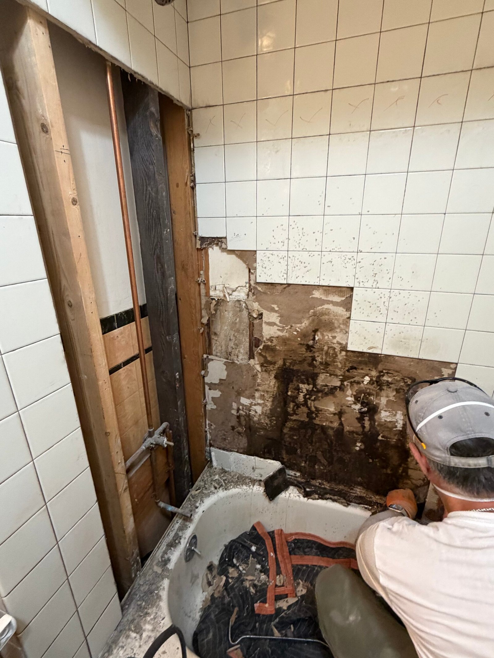More of the backing exposed around the retained bathtub.