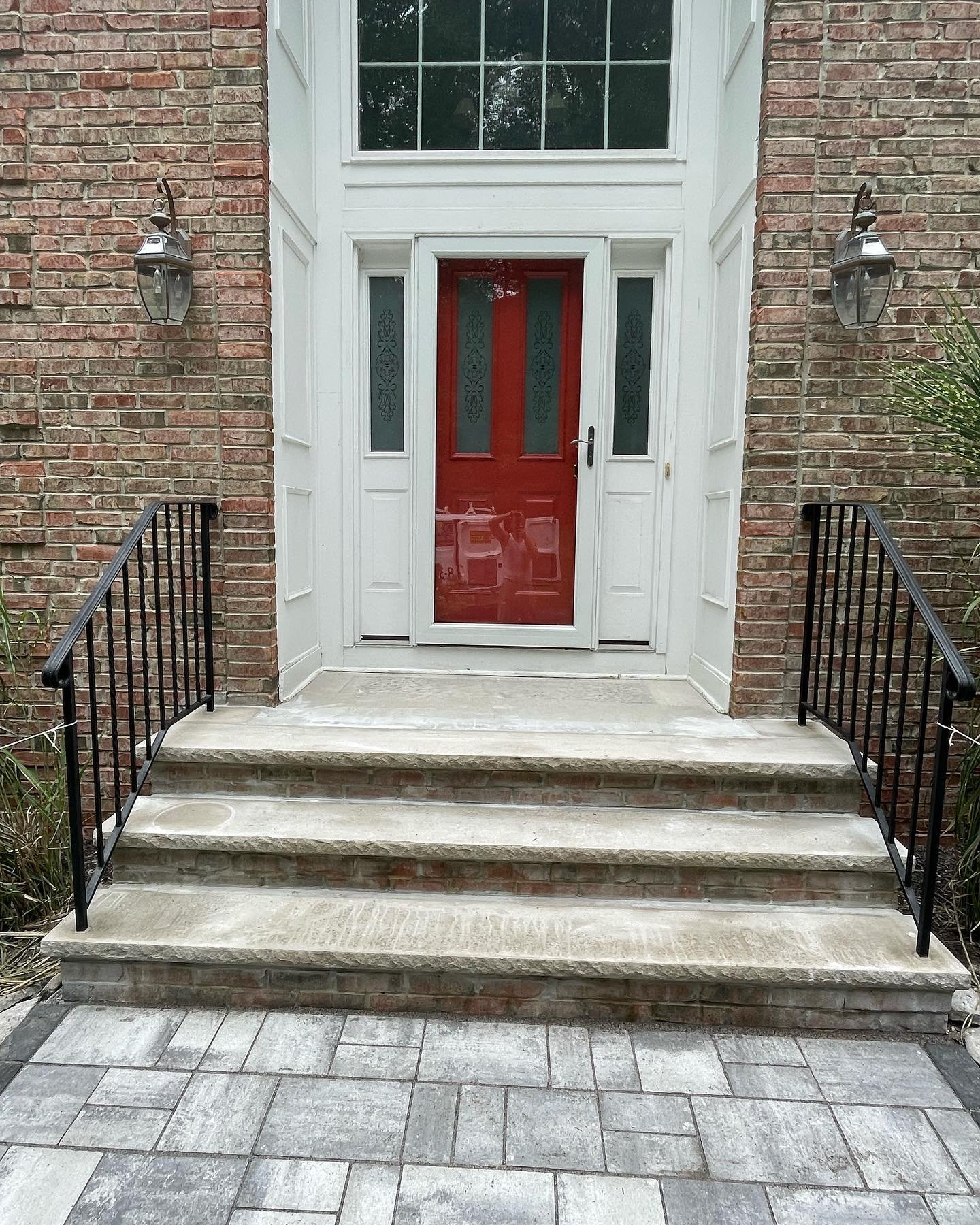 After: the completed limestone steps and restored black railings at the front entrance.
