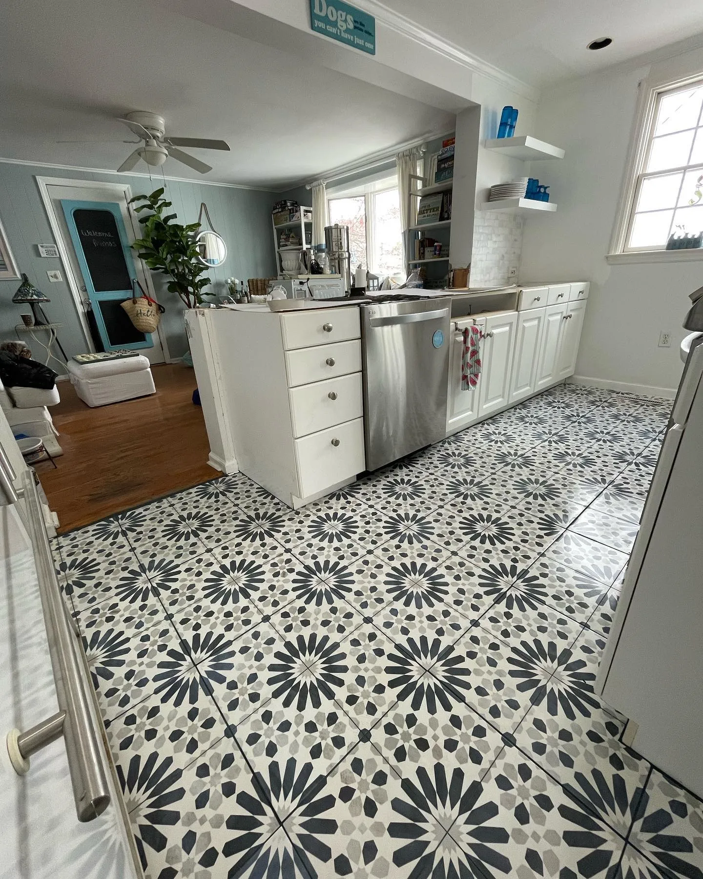 The island area after the tilework, with the patterned kitchen floor installed and the countertop still removed.