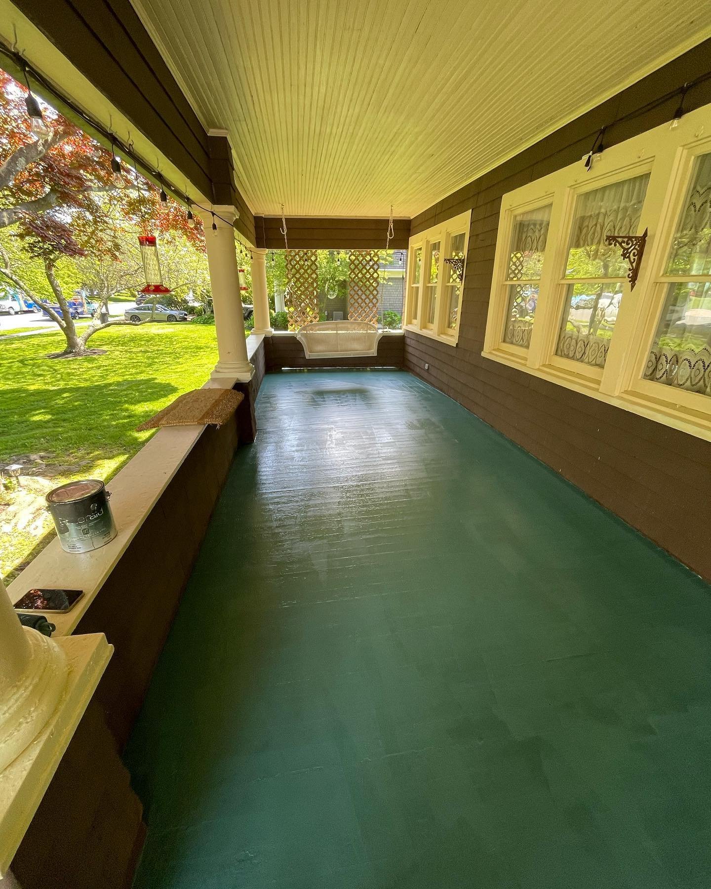 After painting: the renewed blue-green floor along the length of the covered porch.